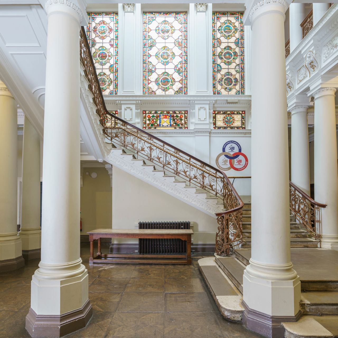 Rendcomb park estate inside of mansion building pictured with stained glass windows and grand staircase