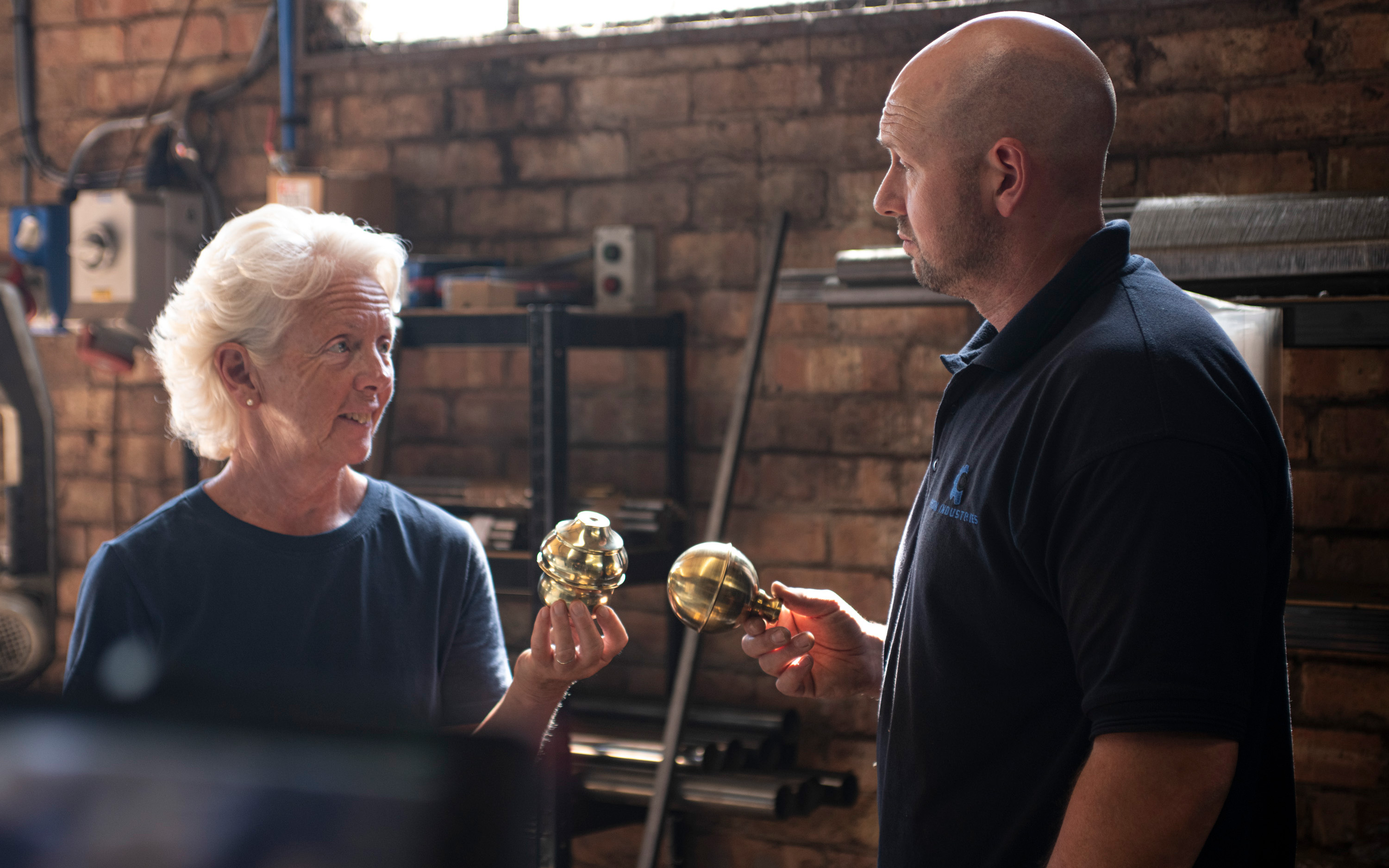 Amanda Oldfield examining brass bed components in the Norfolk workshop