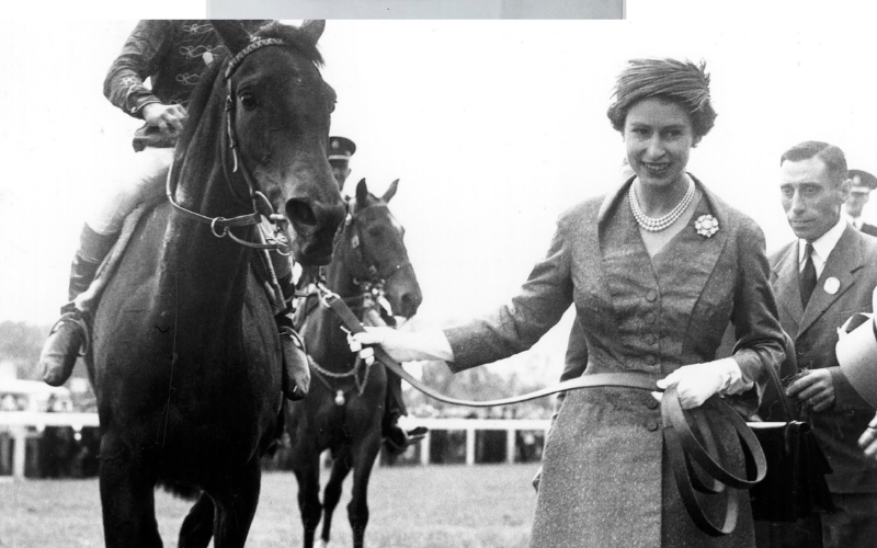 Queen Elizabeth II leads in her first classic winner, Carrozza, after the filly's victory in the Oaks at Epsom