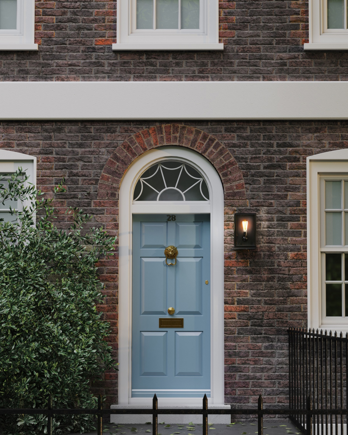 a red brick townhouse with a pale blue door, a brass lion knocker and a black wall light next to the door