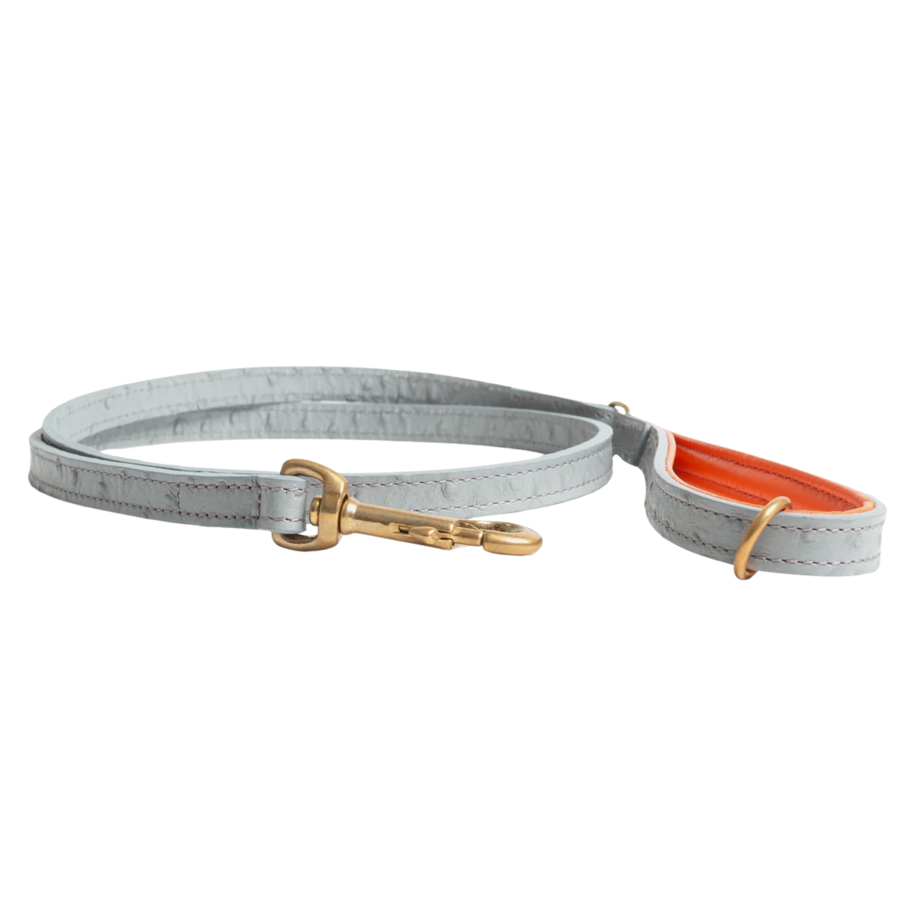 a grey leather dog lead with orange detail and gold hardware