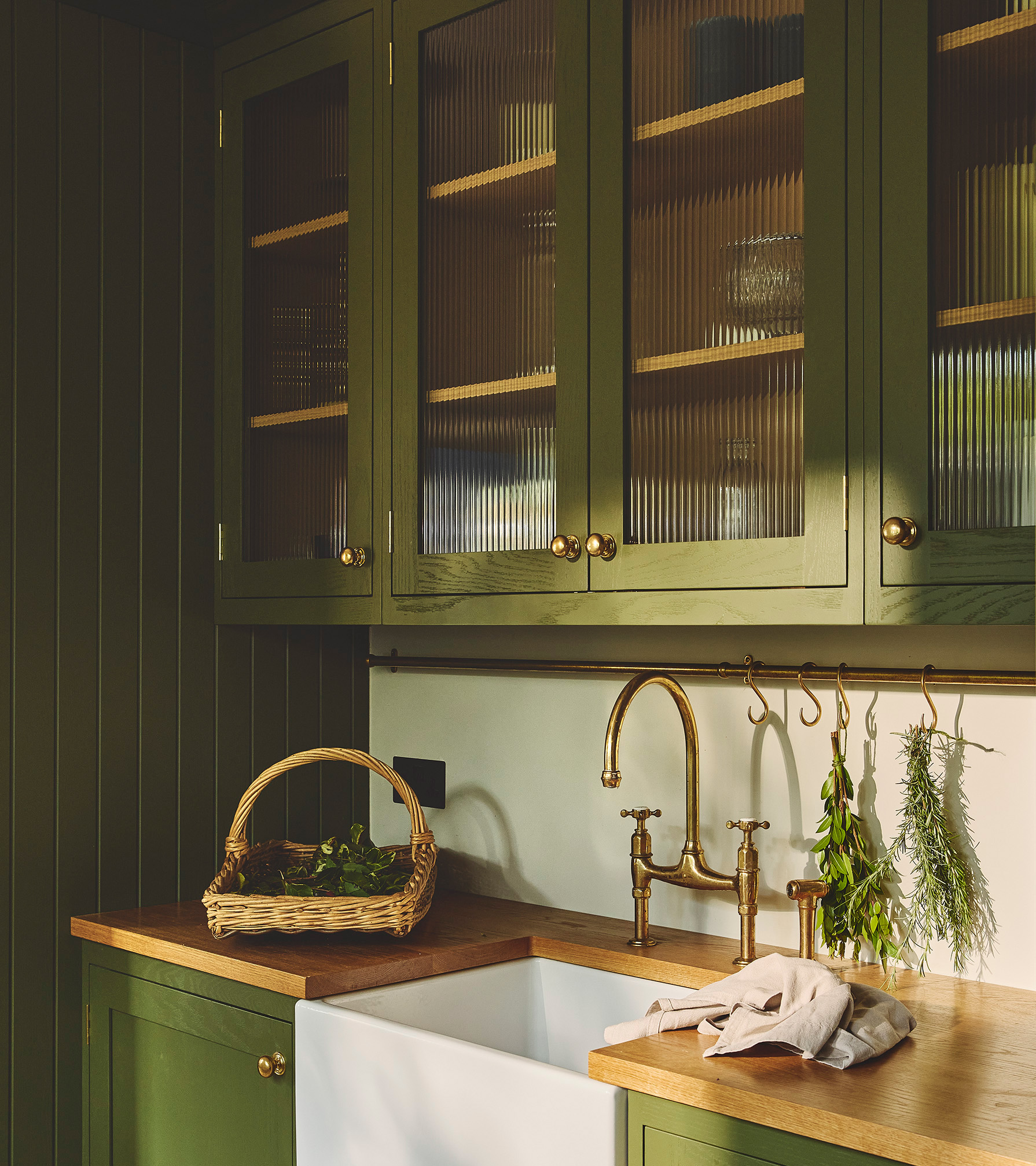 green kitchen cupboards with fluted glass cabinets