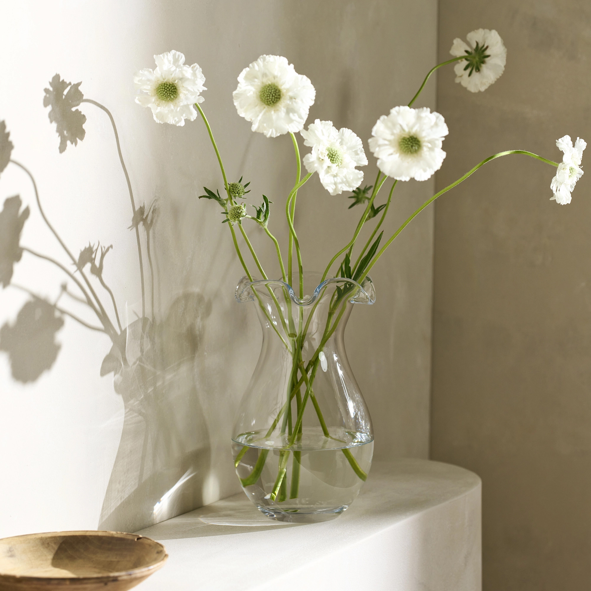 a clear glass vase with a frill edge