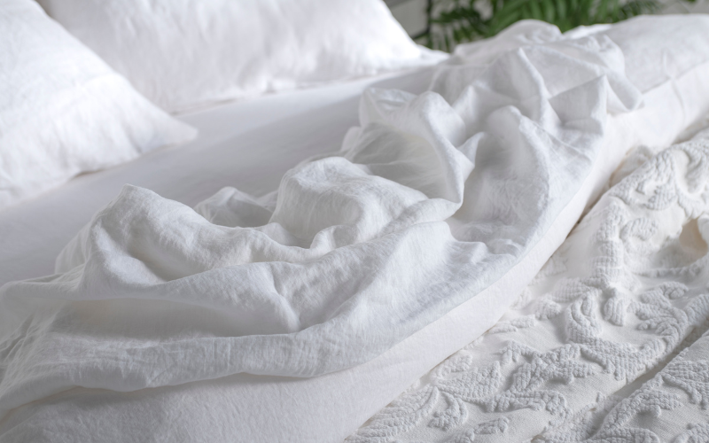 White crumpled bedding on bed