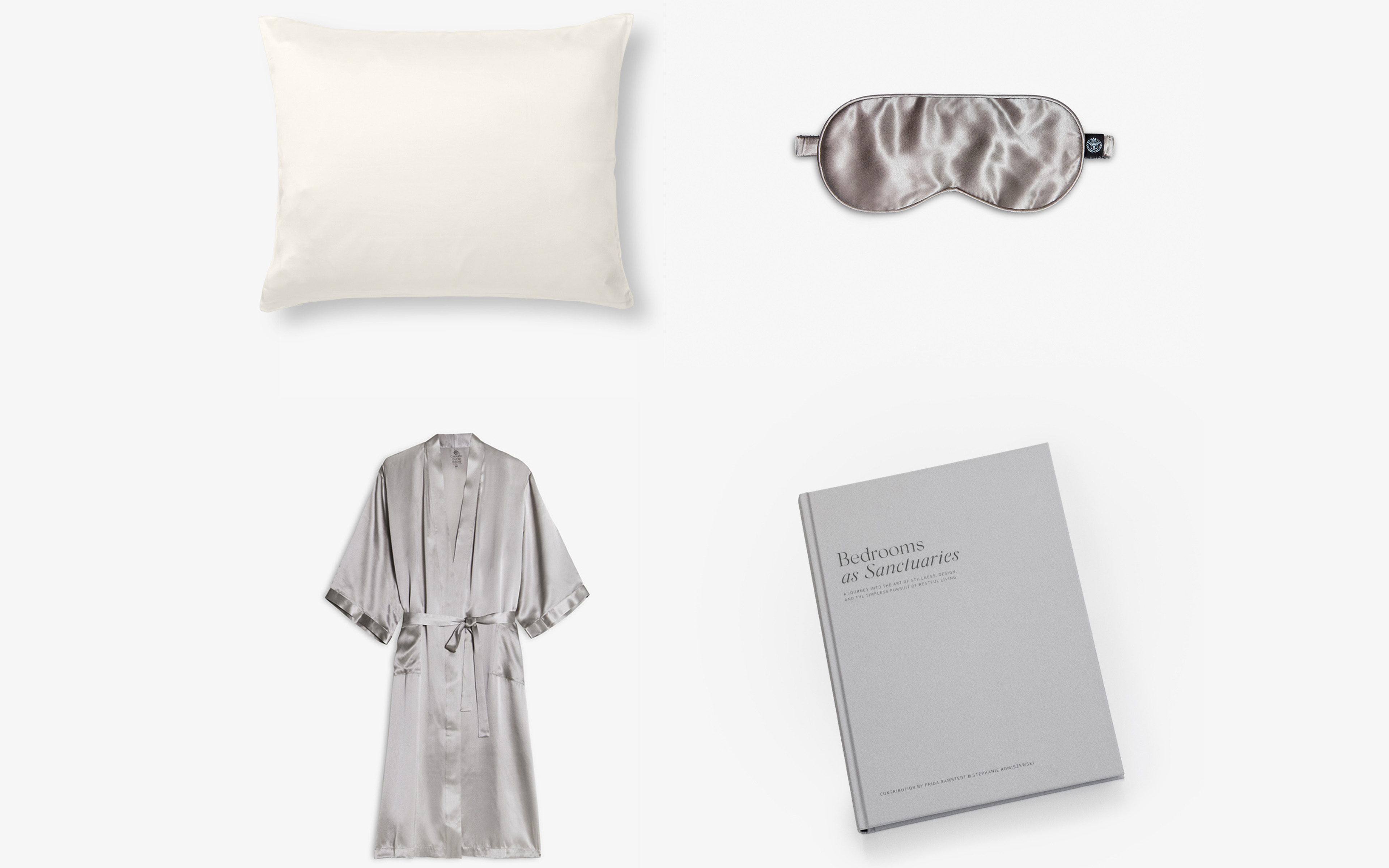 a white silk pillow, a grey silk eye mask, a grey silk robe and a grey coffee table book
