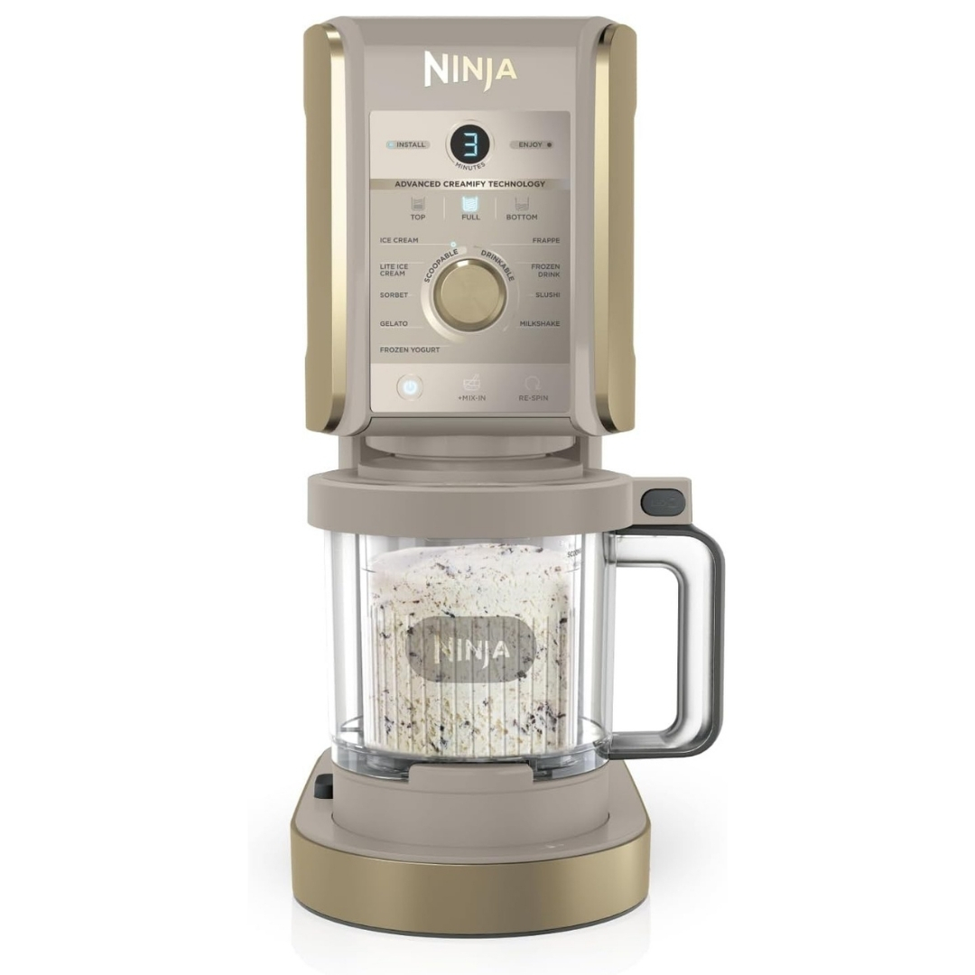 Ninja CREAMi Deluxe pictured with ice cream inside on a white background