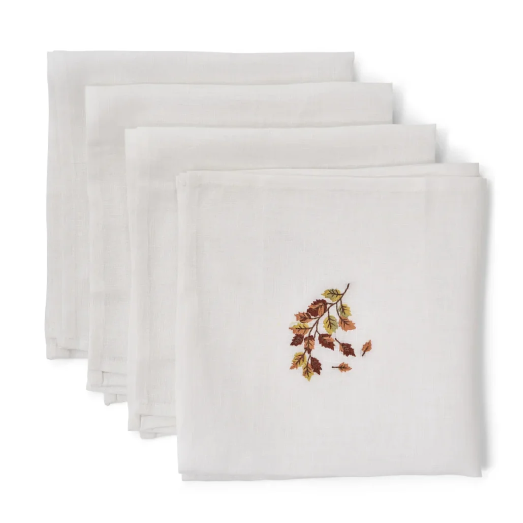 a set of 4 white linen napkins with brown embroidered autumn leaves