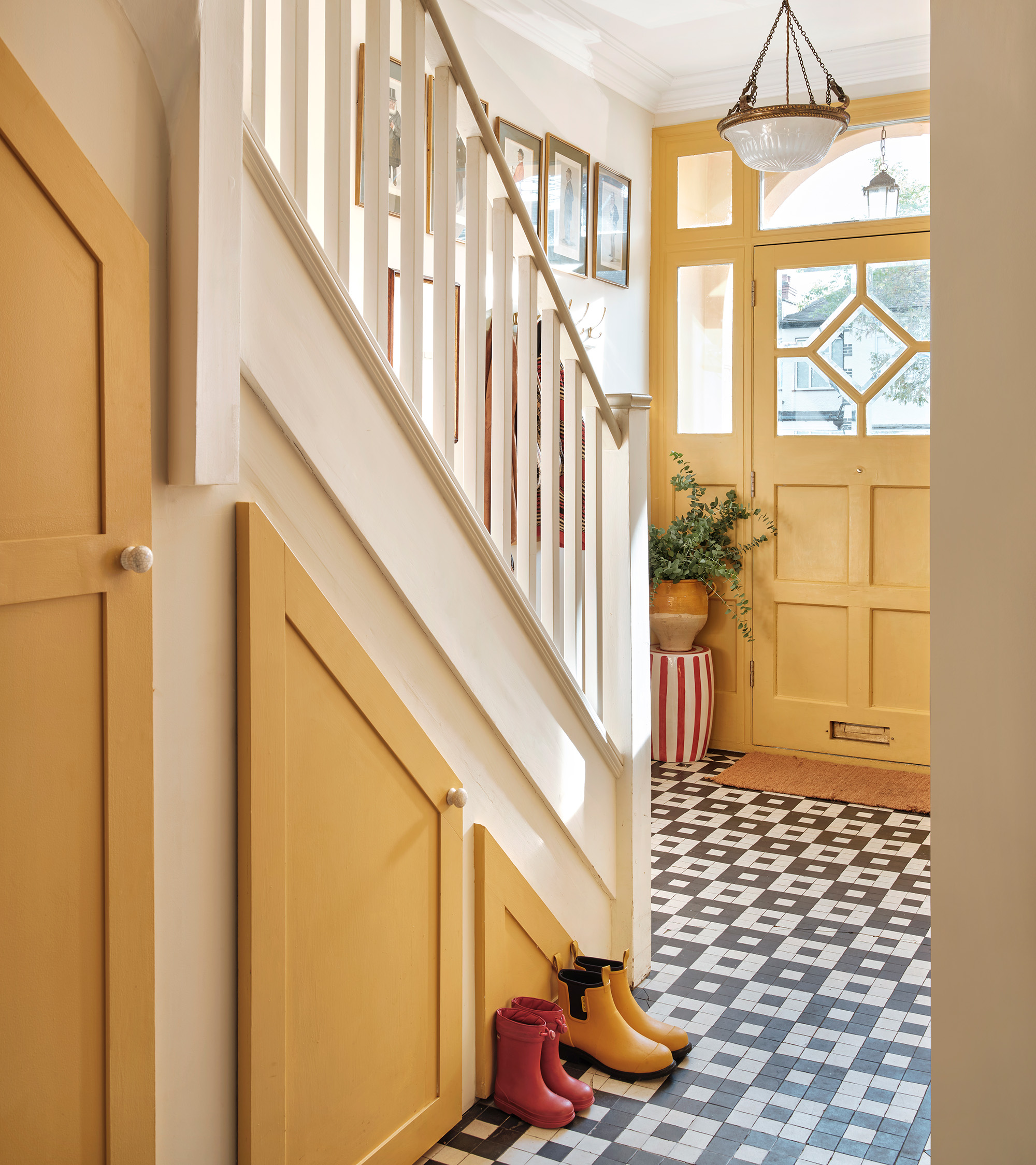 a yellow and white hallway with black and white floor