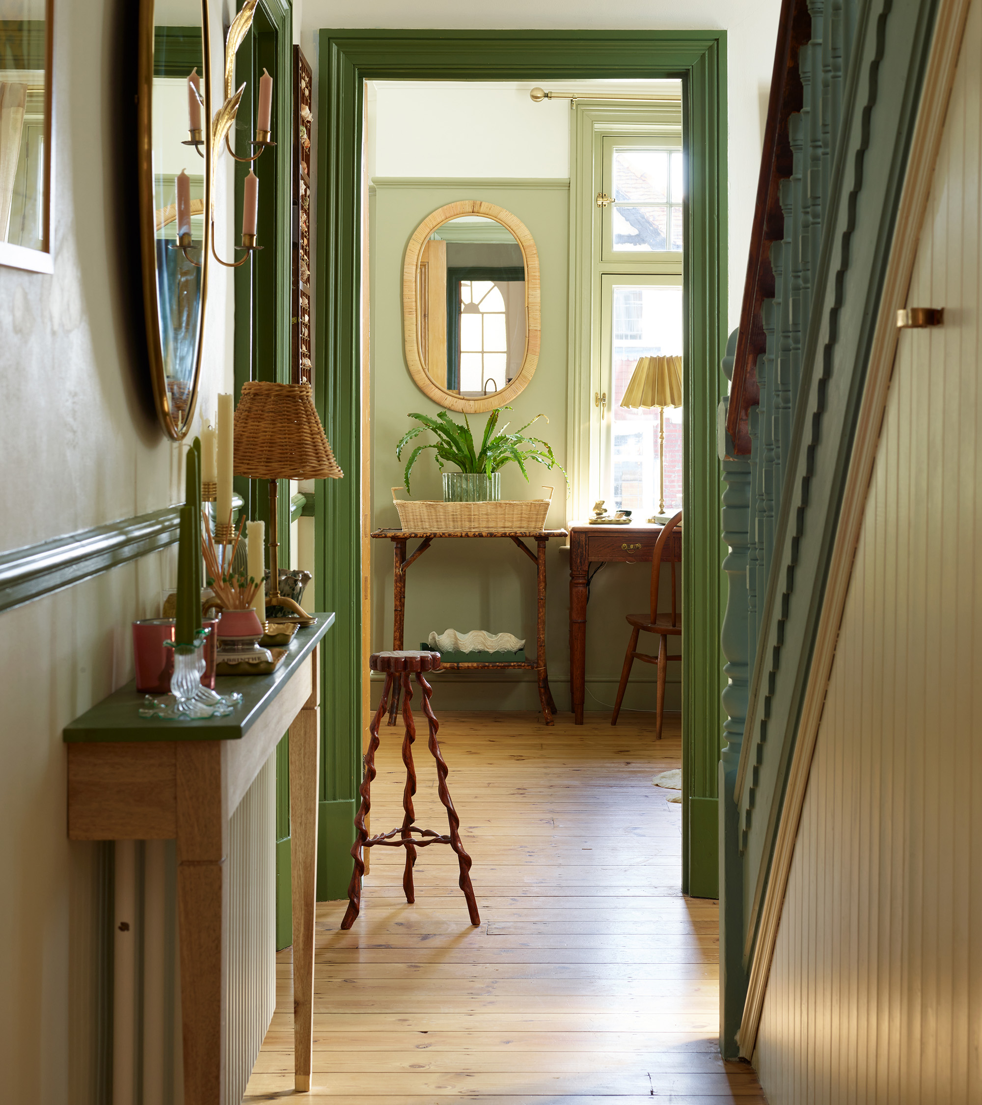 a narrow hallway with blue staircase