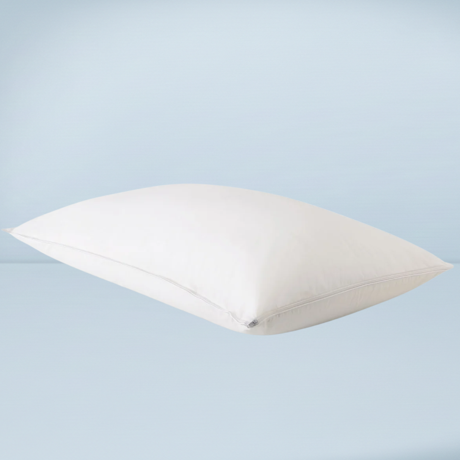 a white pillow on a pale blue background