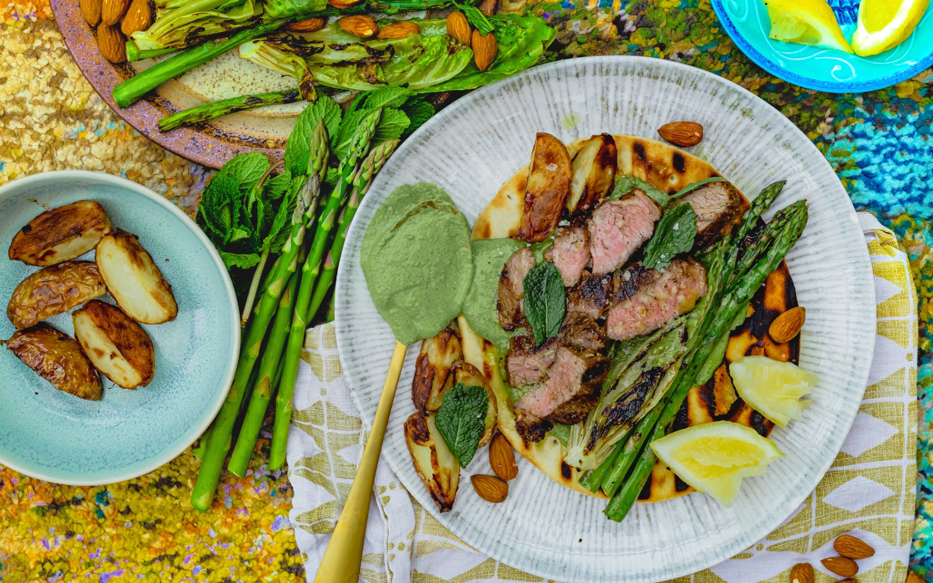 a plate with a lamb shawarma on a flatbread with a green pea pesto and asparagus