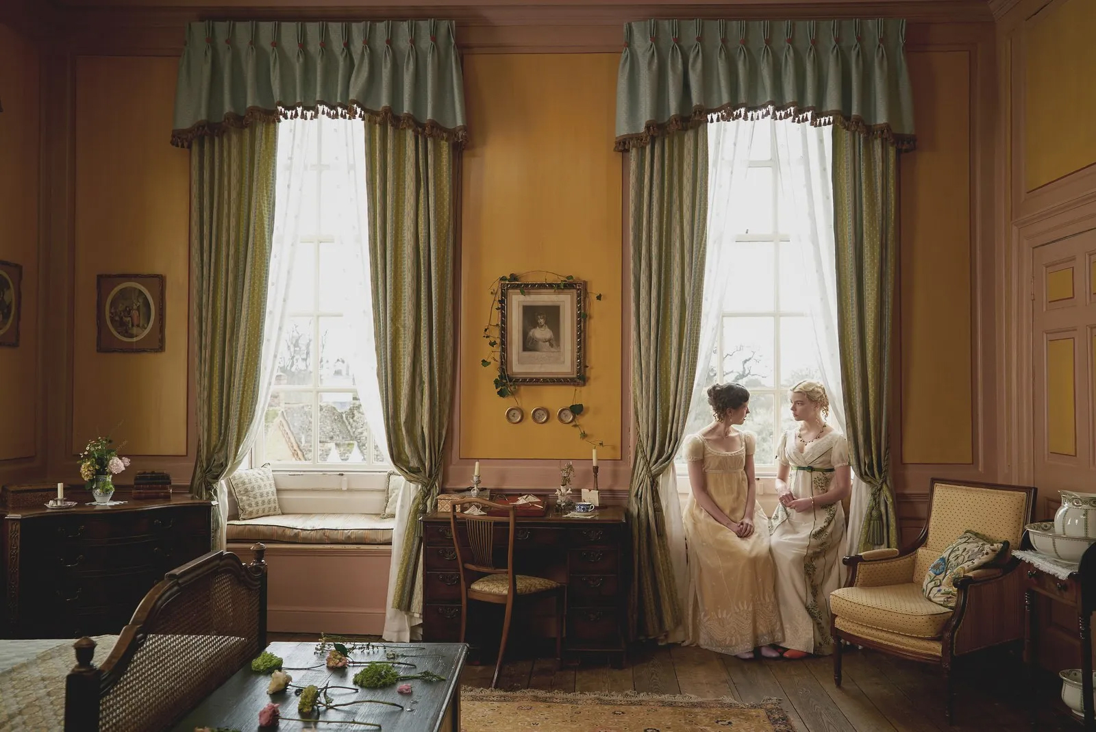 a traditional bedroom with yellow walls and long green draped curtains from the movie Emma