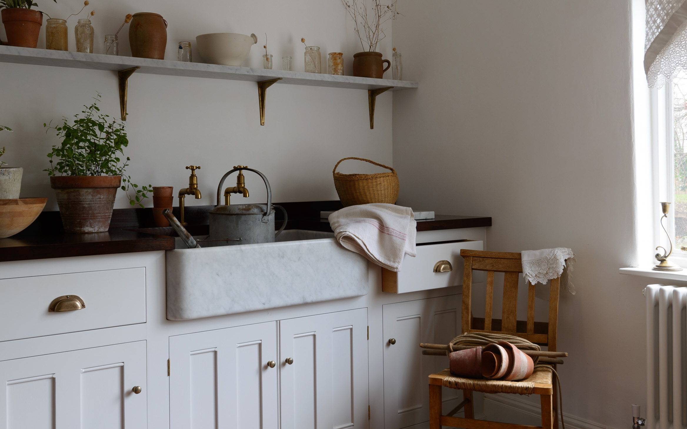 a white kitchen with a belfast sink