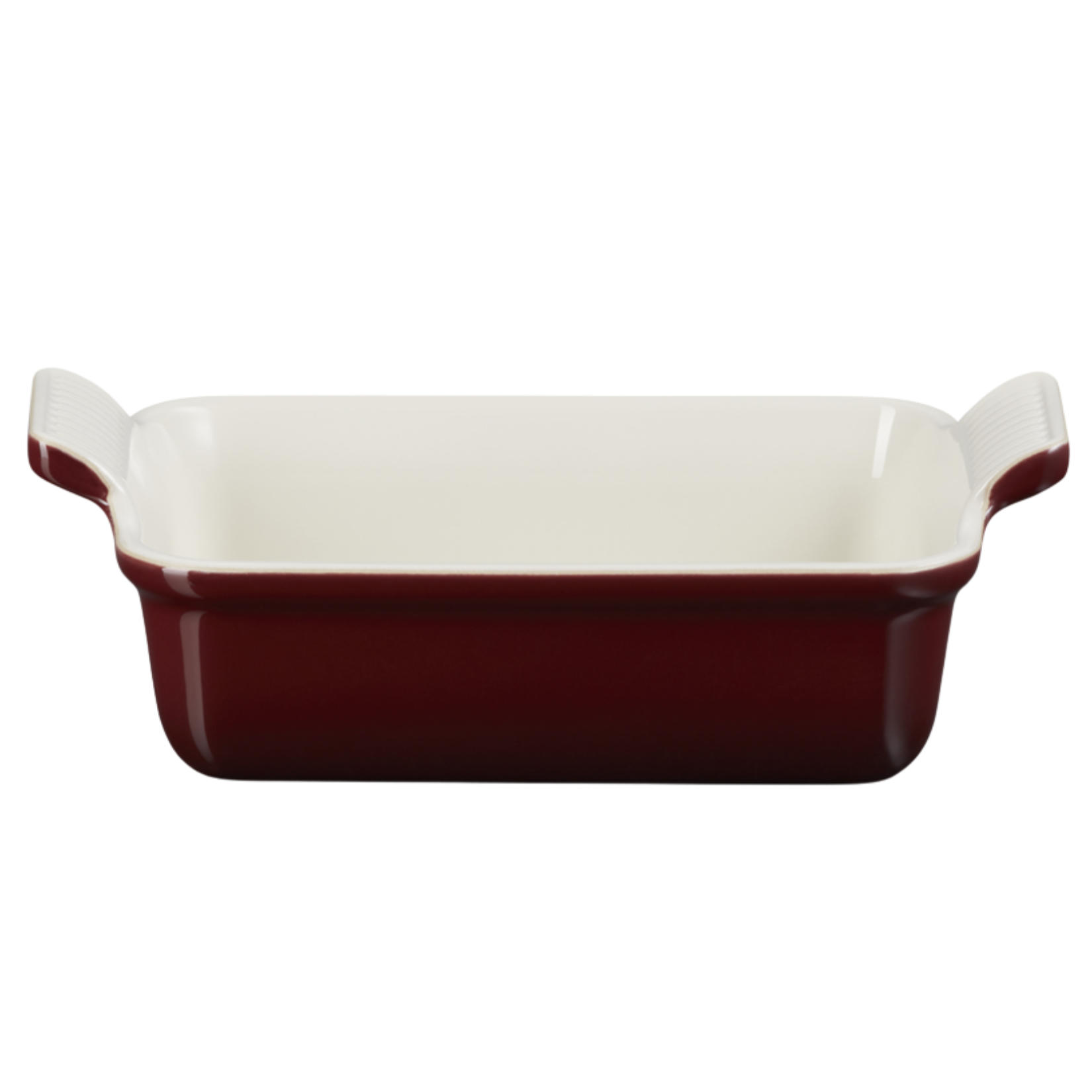 Deep burgundy red ceramic rectangular baking dish with an off-white interior and raised side handles