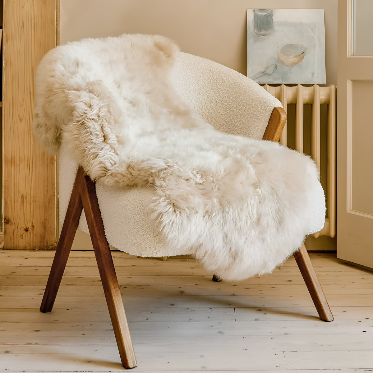 a white sheepskin rug draped over a borg armchair