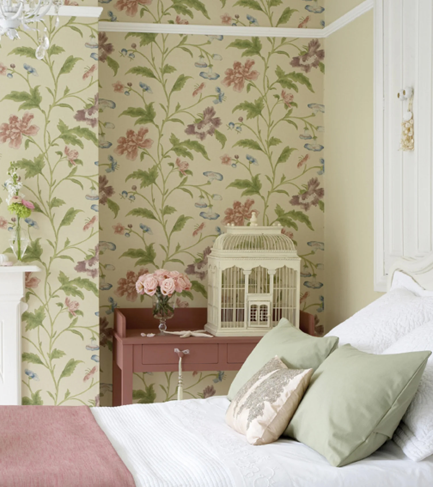 a bedroom with yellowish cream floral wallpaper and a bed with white bedding and a pink bed spread