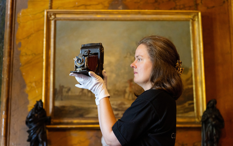 Curator Eleanor Matthews examines Alf's historic Kodak camera