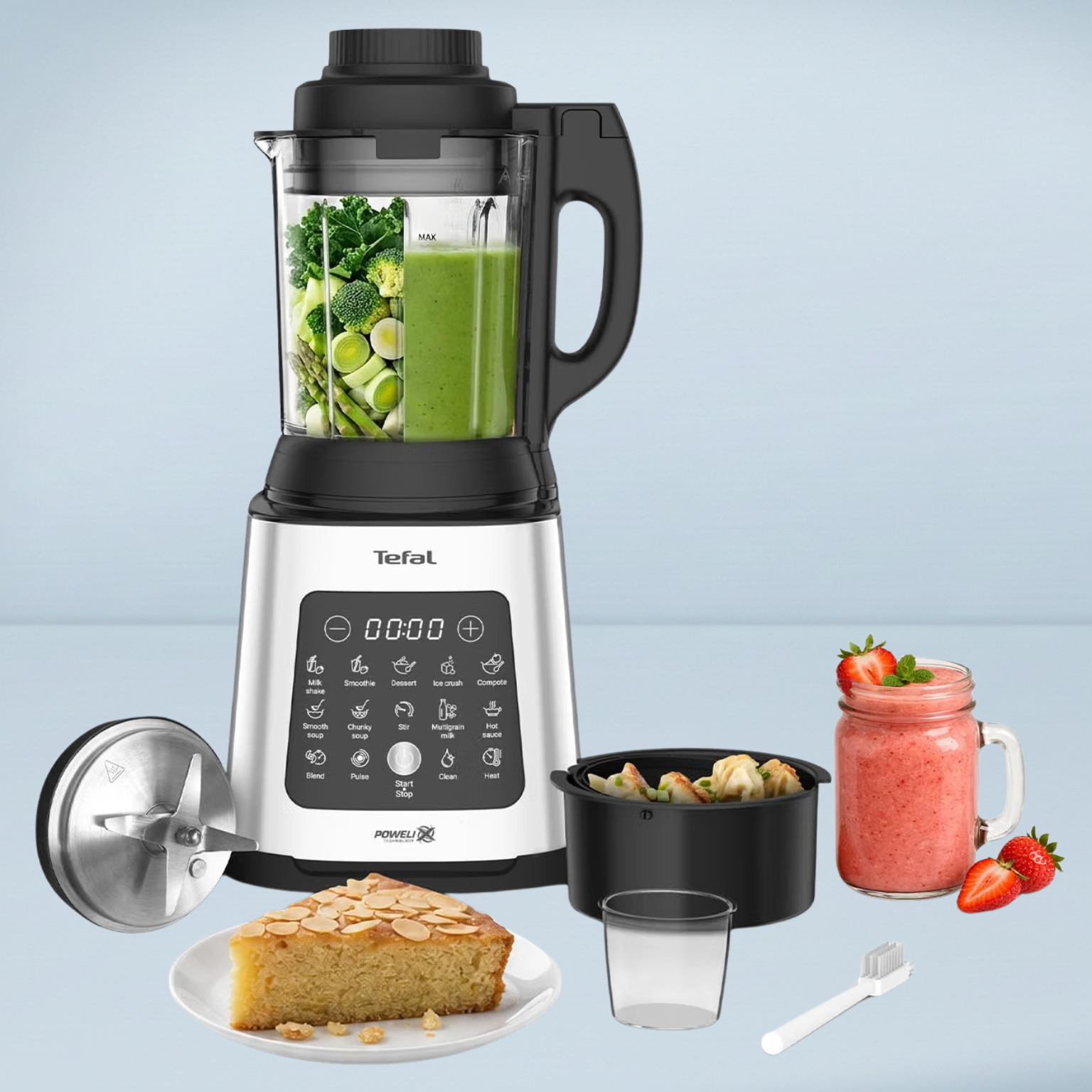 tefal soup maker and blender with a green smoothie inside with accessories, a cake and a jar of pink smoothie next to it