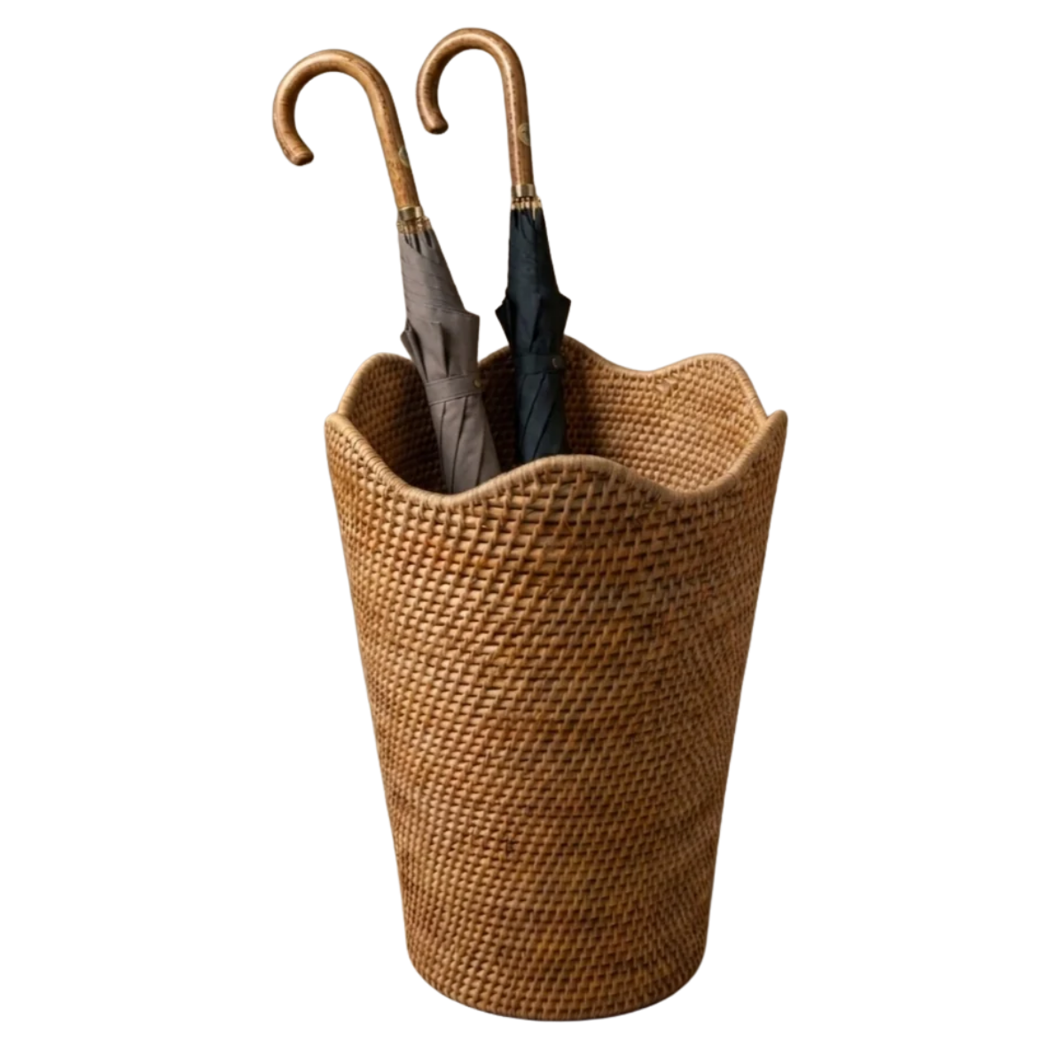 a rattan scalloped umbrella bucket with two umbrellas inside