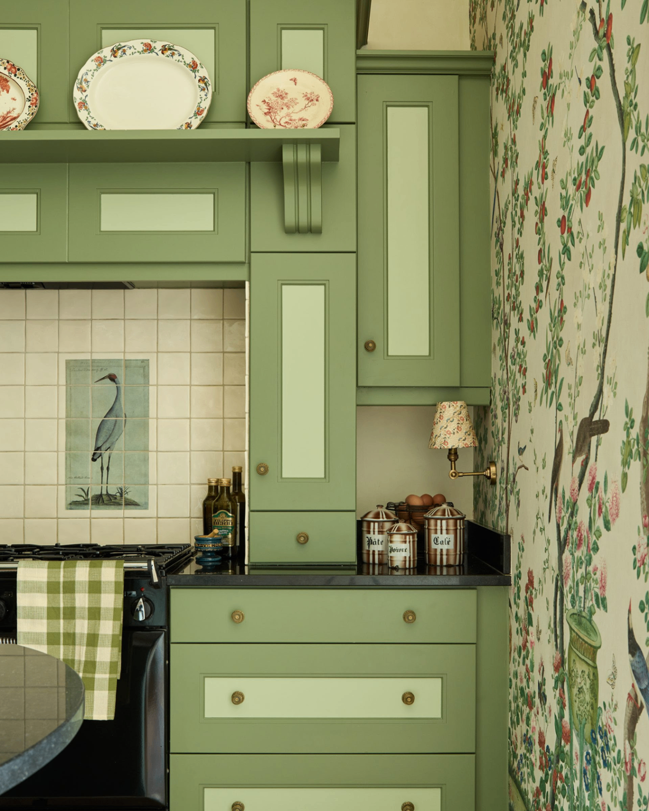 green kitchen with tile bird splashback