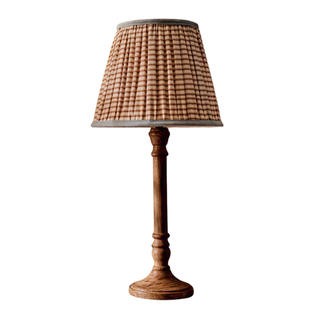 a red and white stripe pleated lampshade on a wooden base