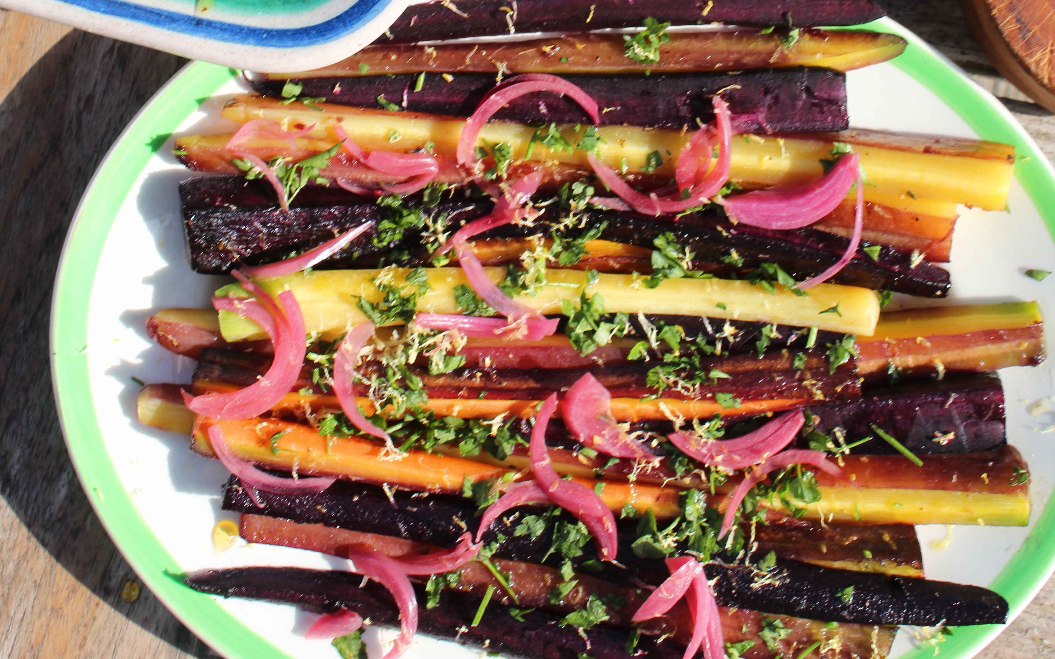rainbow carrots on a white and green plate