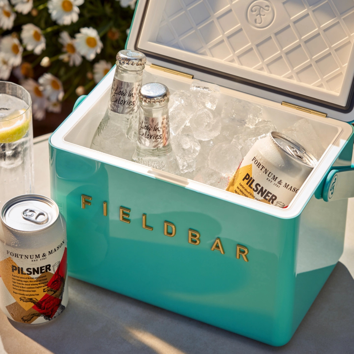 a turquoise blue mini bar cooler box with ice and beer inside