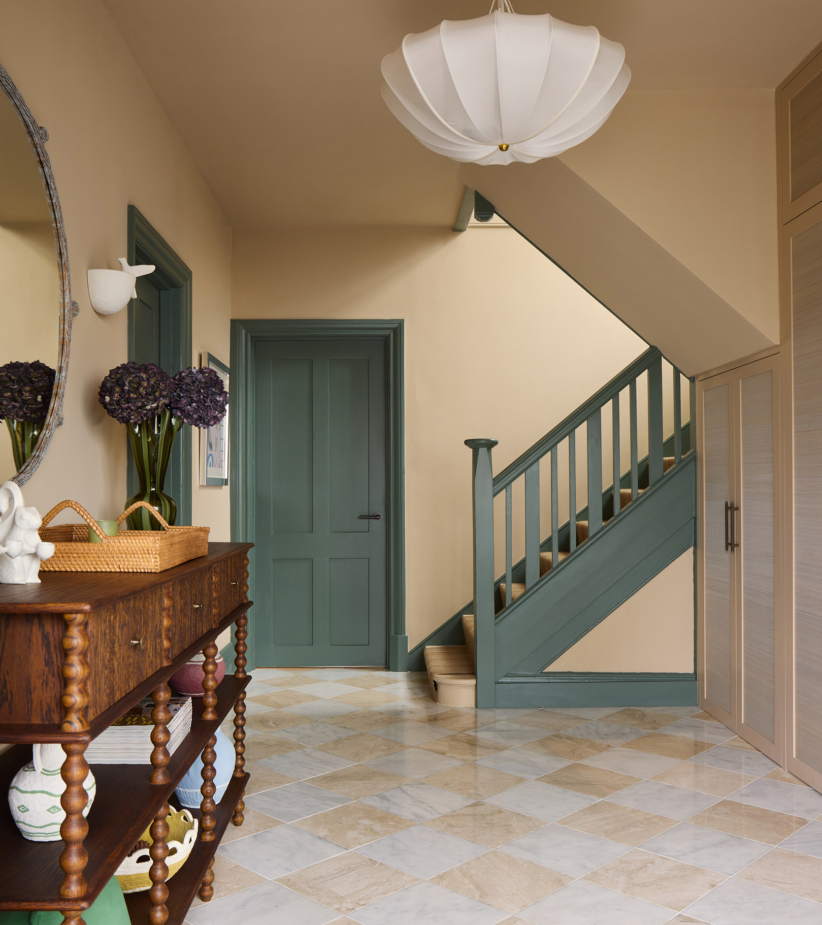 hallway with green door and staircase