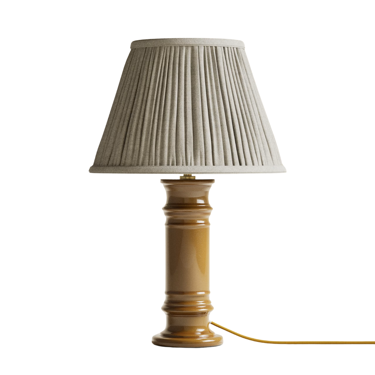 AN OCHRE CERAMIC LAMP WITH A BEIGE PLEATED SHADE