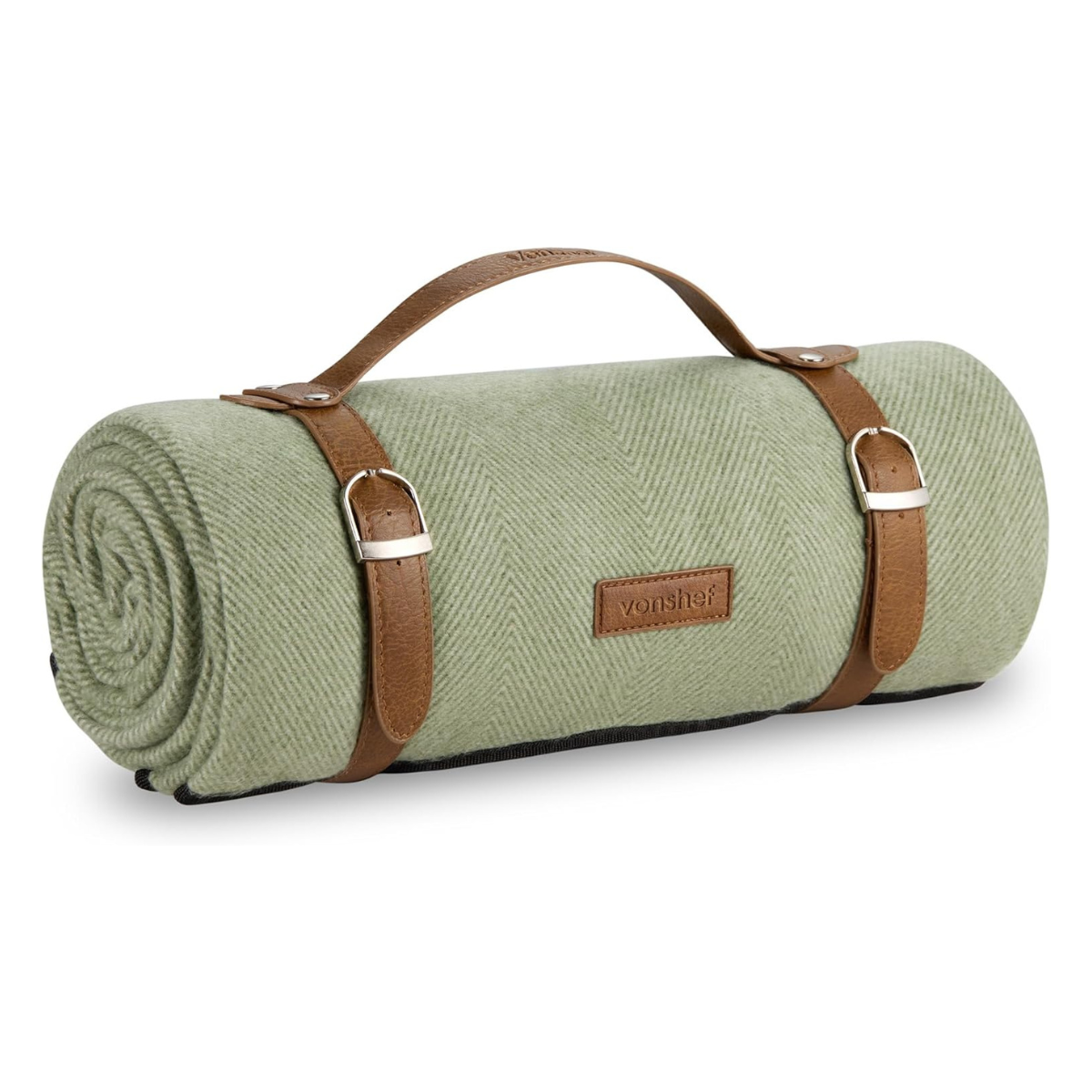 a green herringbone picnic blanket with brown straps