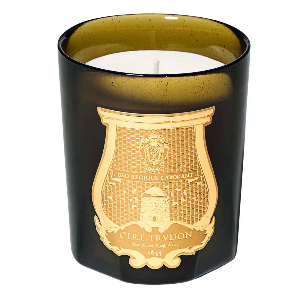 a dark green glass candle with a gold label