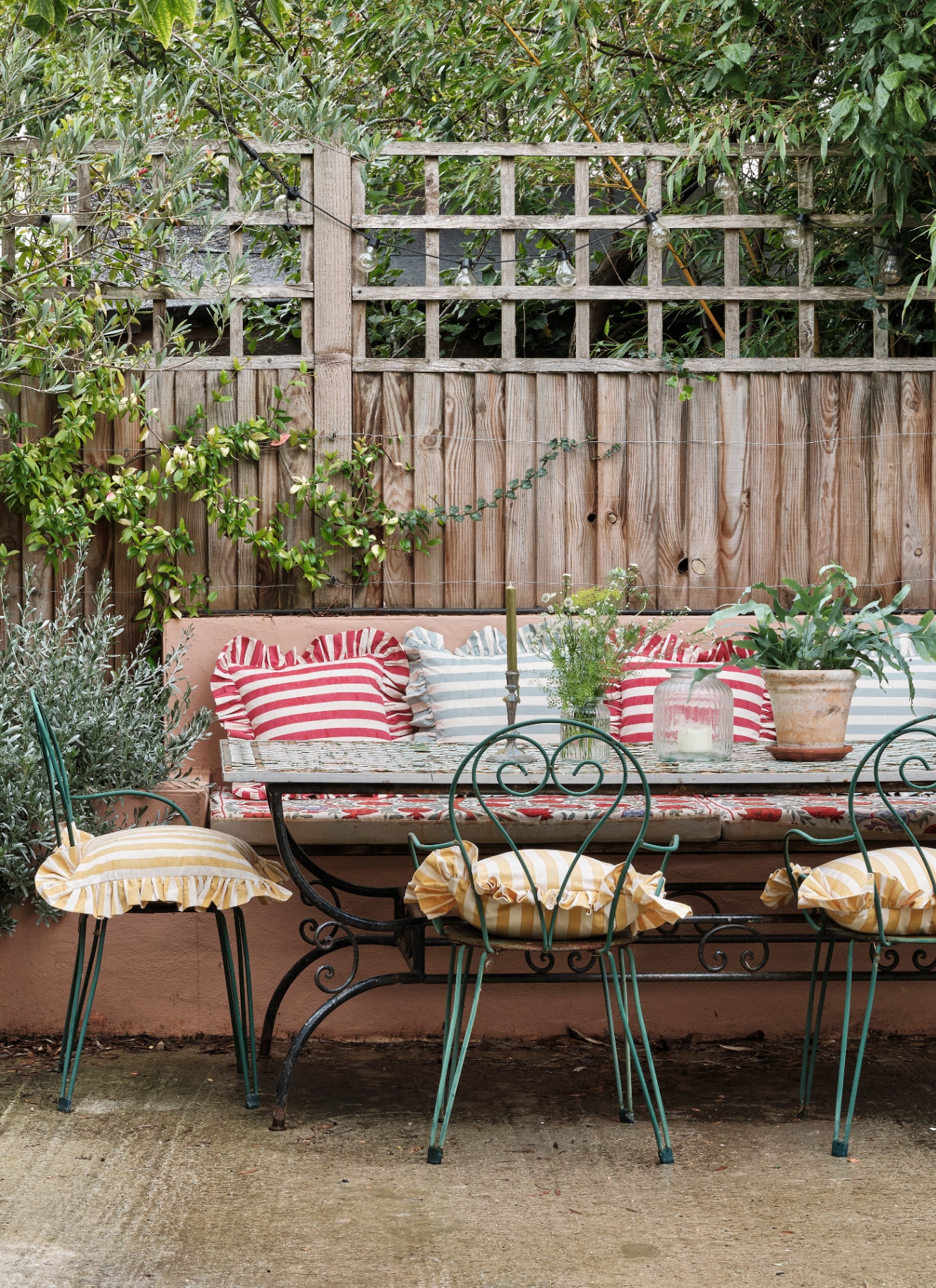 outdoor furniture with multicoloured frilled striped cushions