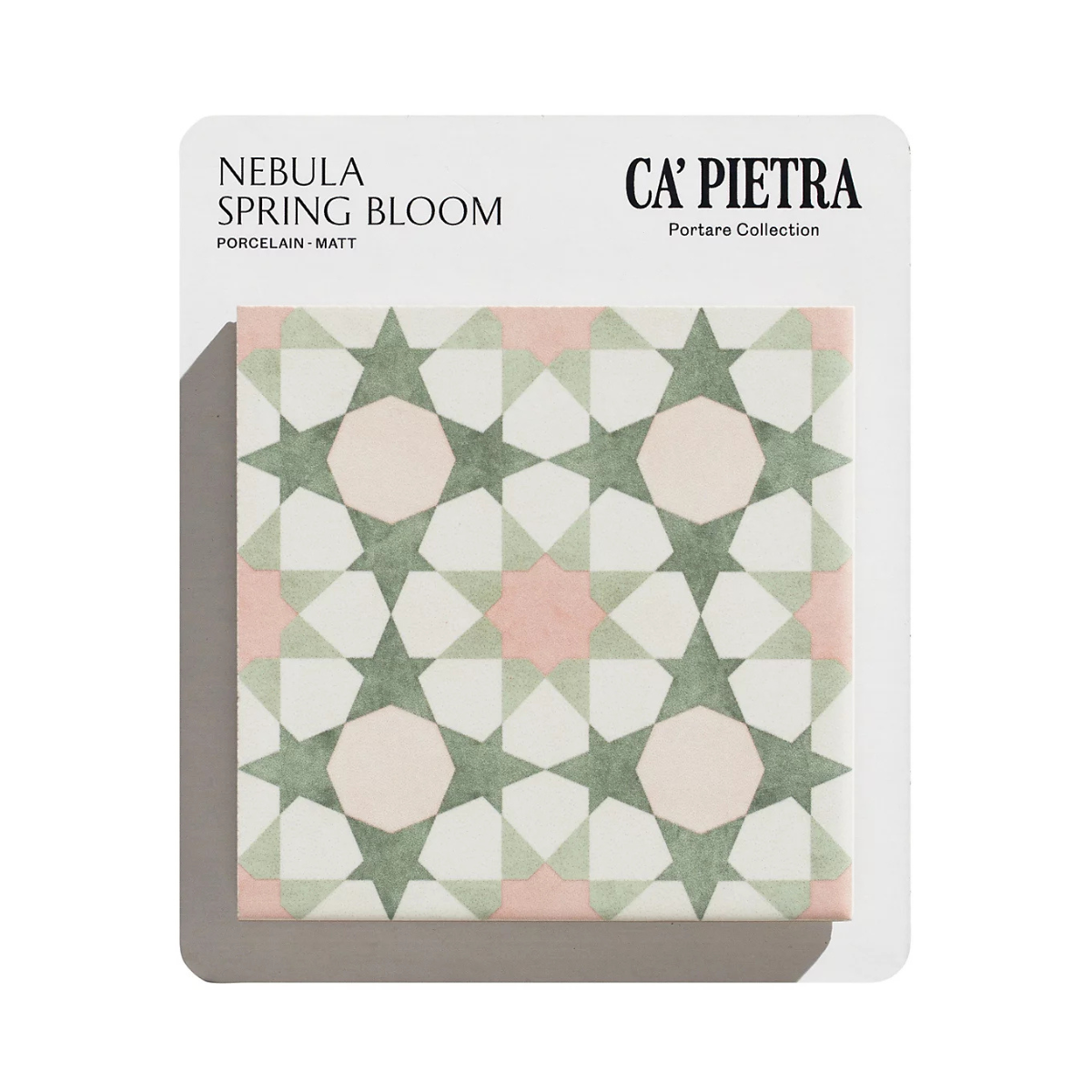 a white, green and pink star patterned porcelain tile on a white background
