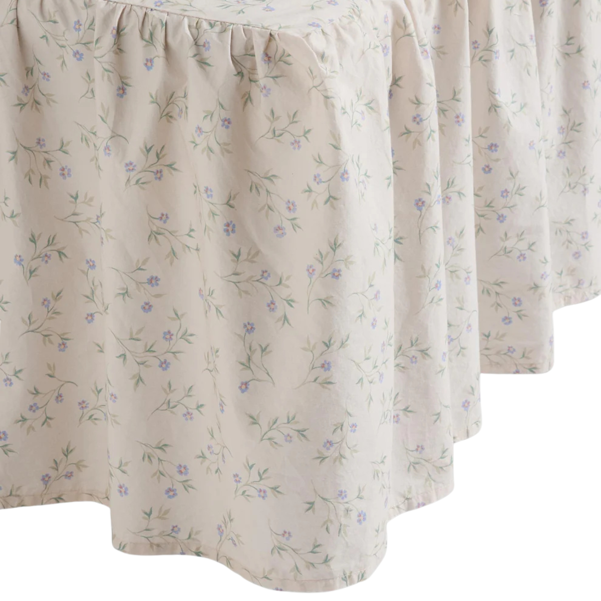 a white bed valance with blue ditsy florals
