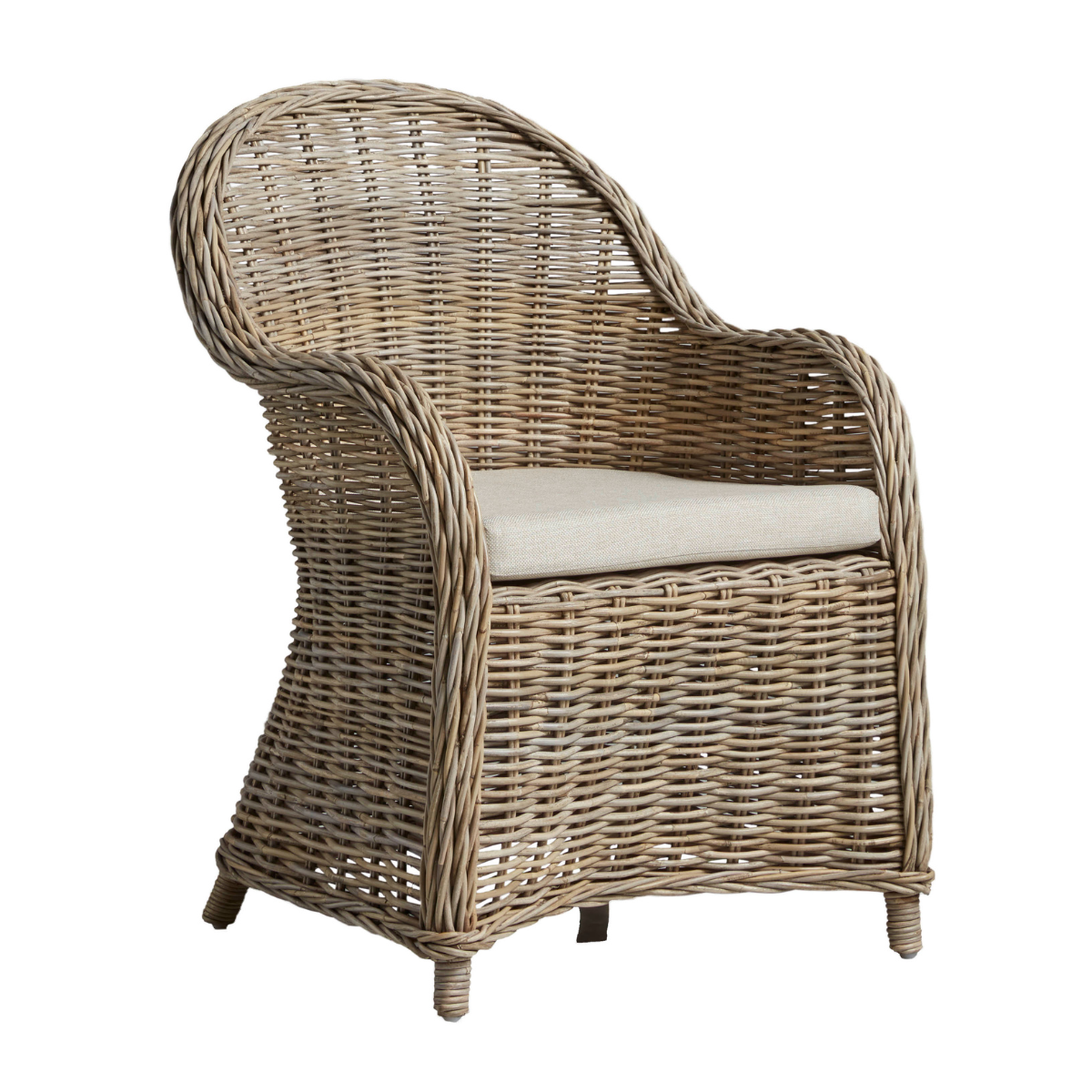 a woven rattan chair with a cream seat pad