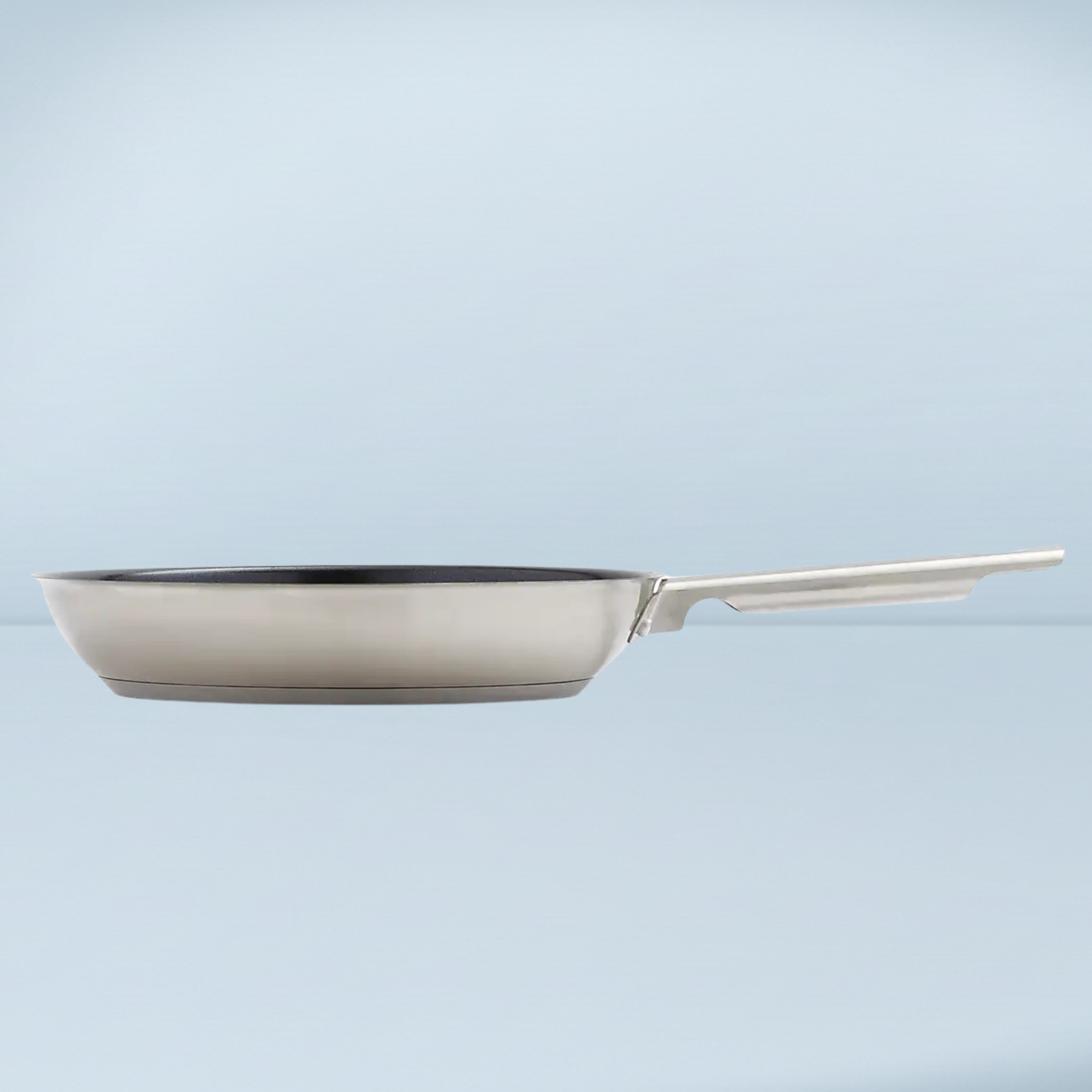 a silver frying pan with a black interior