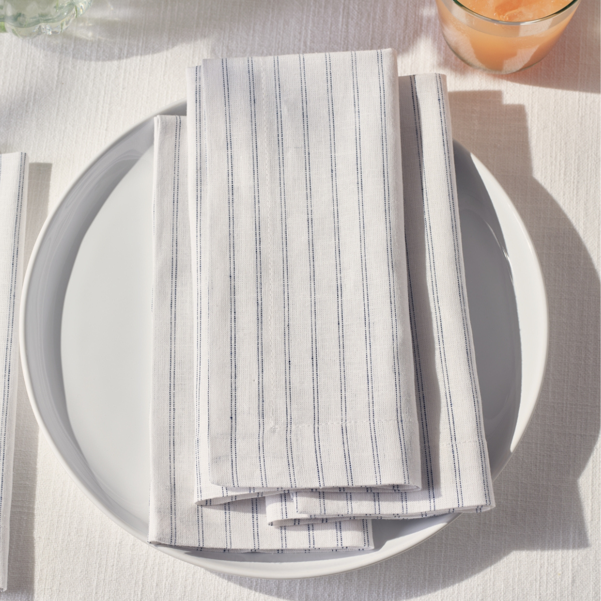 white and navy striped napkins on a white plate