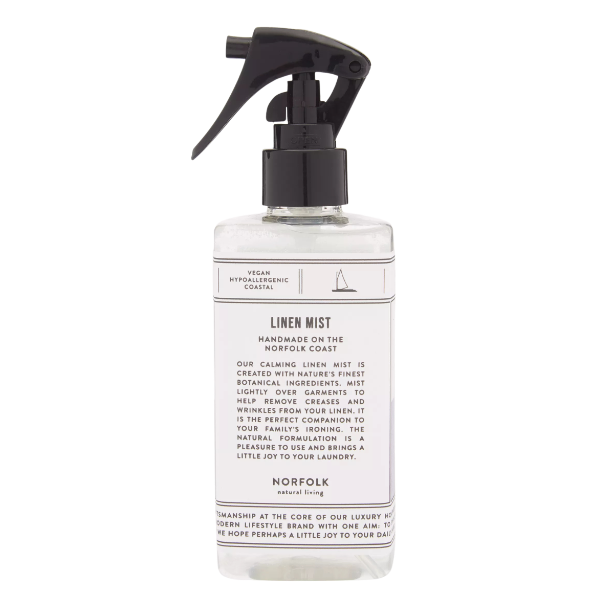 a bottle of linen mist with a clear bottle, black nozzle and a white label with black writing