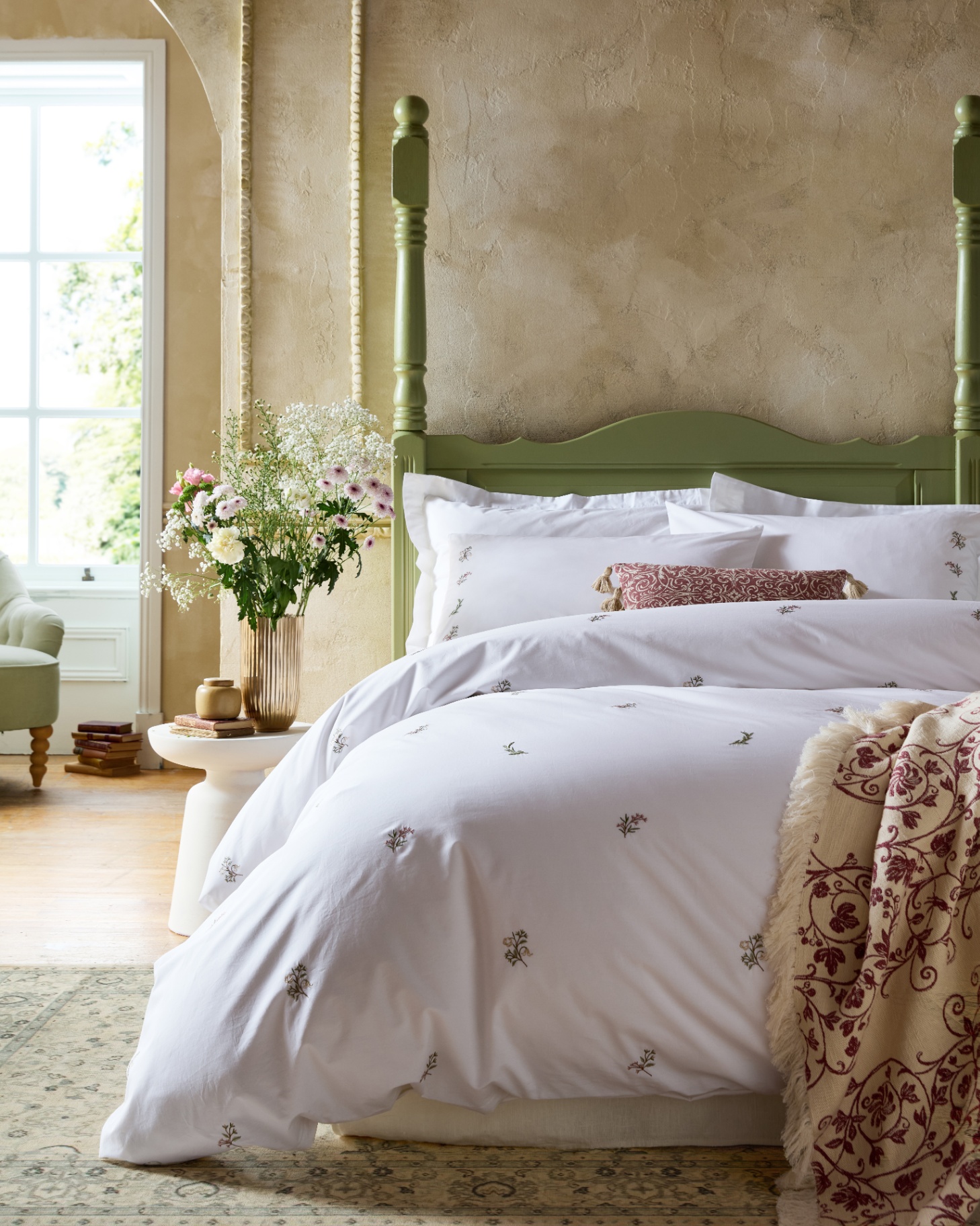 Victoria Sprigs Embroidery by Ashley Wilde Group on a green four poster bed