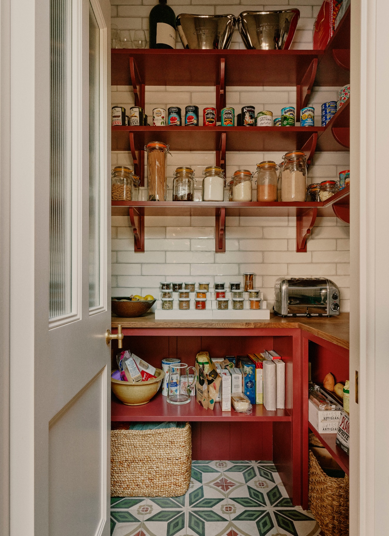 a pantry cupbaord with red shelves