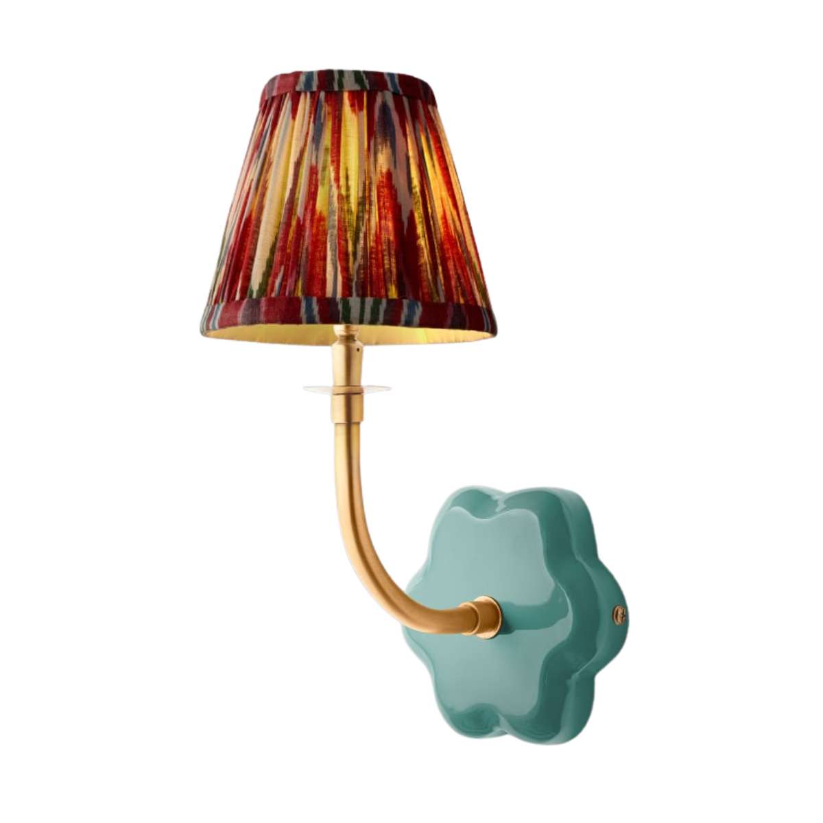a wall light with a turqoise wall fitting, gold hardware and a small red pleated ikat shade