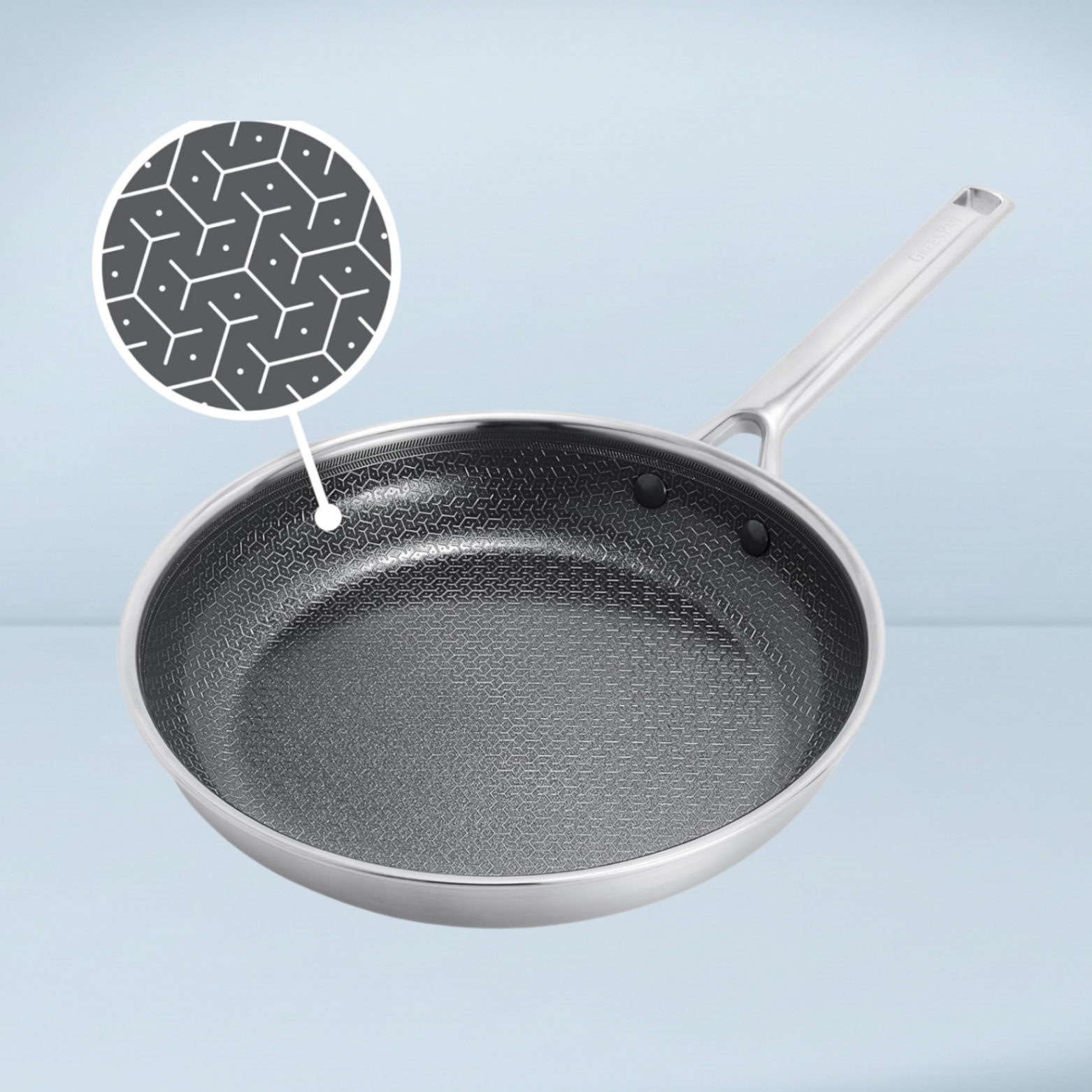 a silver frying pan with a black and silver patterned interior