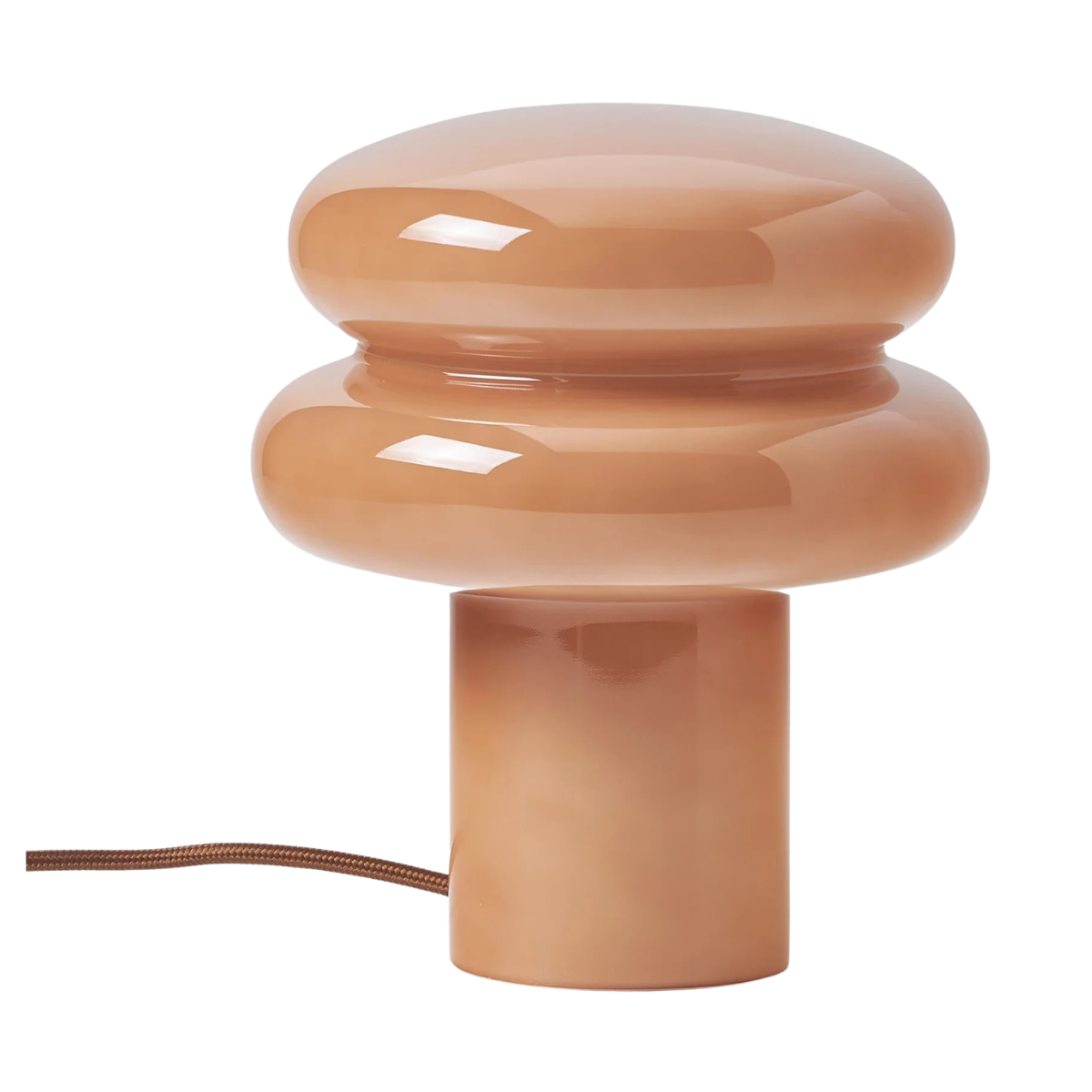 a pale peach toned circular sculptural table lamp
