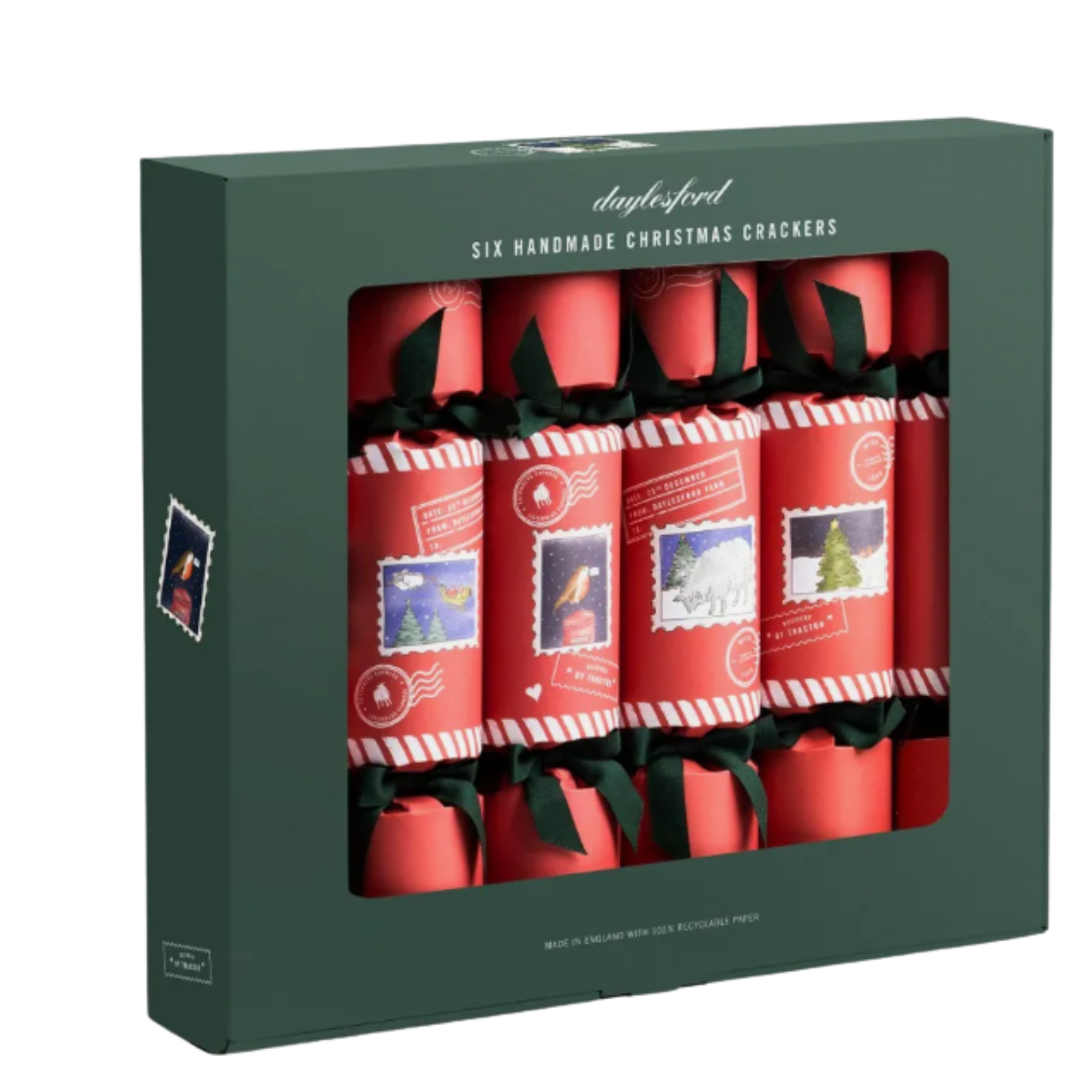 Boxed set of six Daylesford Organic Christmas crackers in a dark green box. Wrapped in red paper with candy cane striped borders and green ribbon bows, each features postage stamp illustrations of festive farm scenes, sheep, robins, and trees