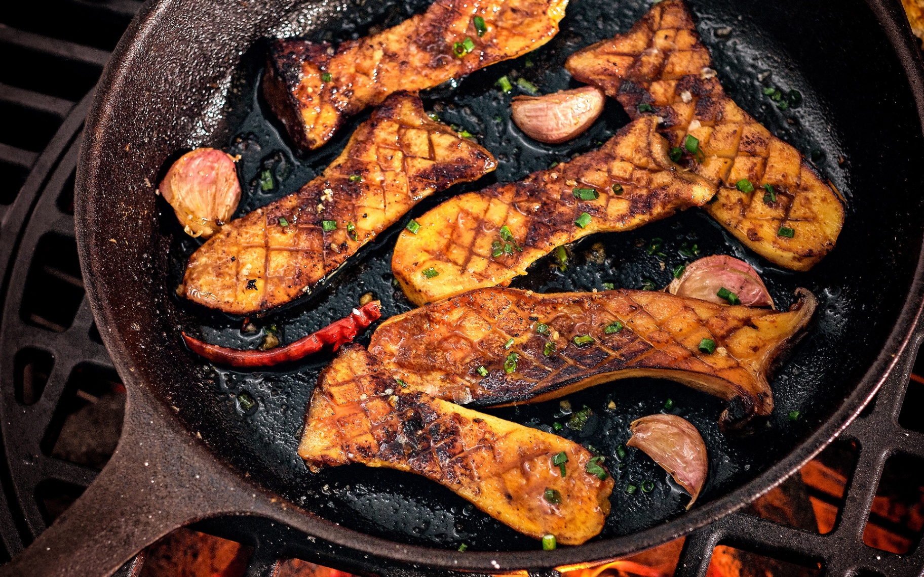 bbq oyster mushrooms in a griddle pan on a bbq fire