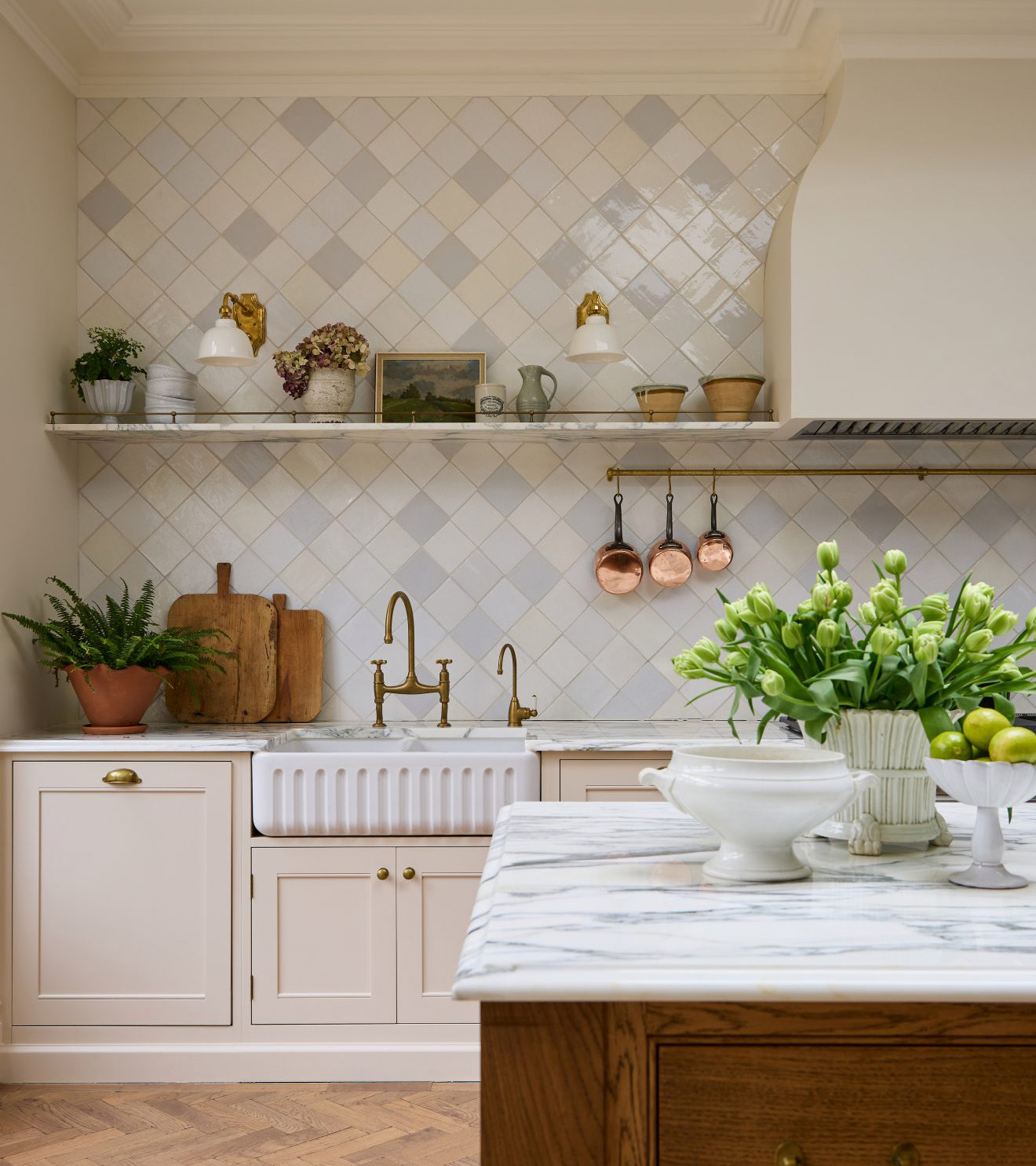 a white kitchen with white tiles and wooden kitchen island