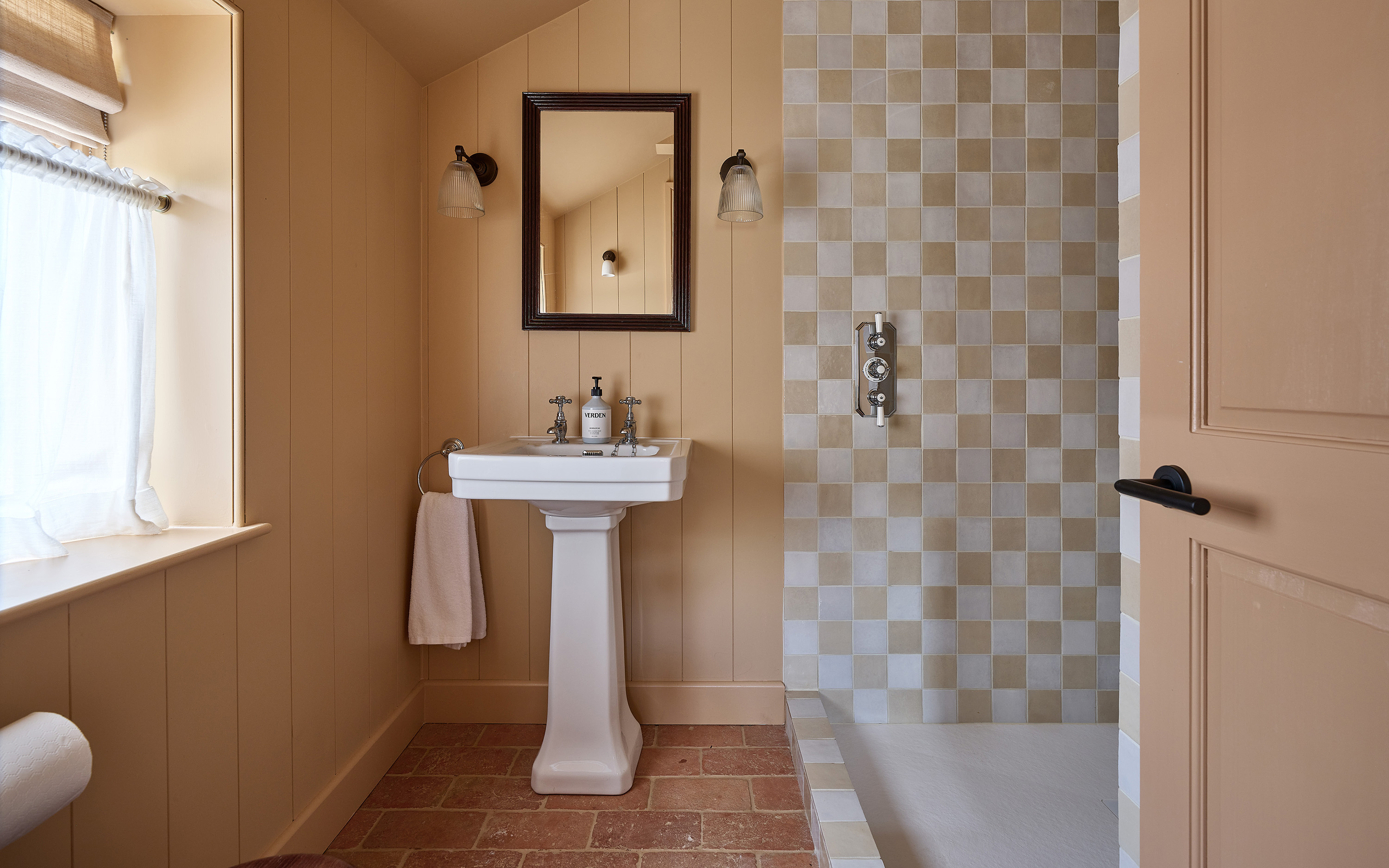 a yellow bathroom with checkered tiles