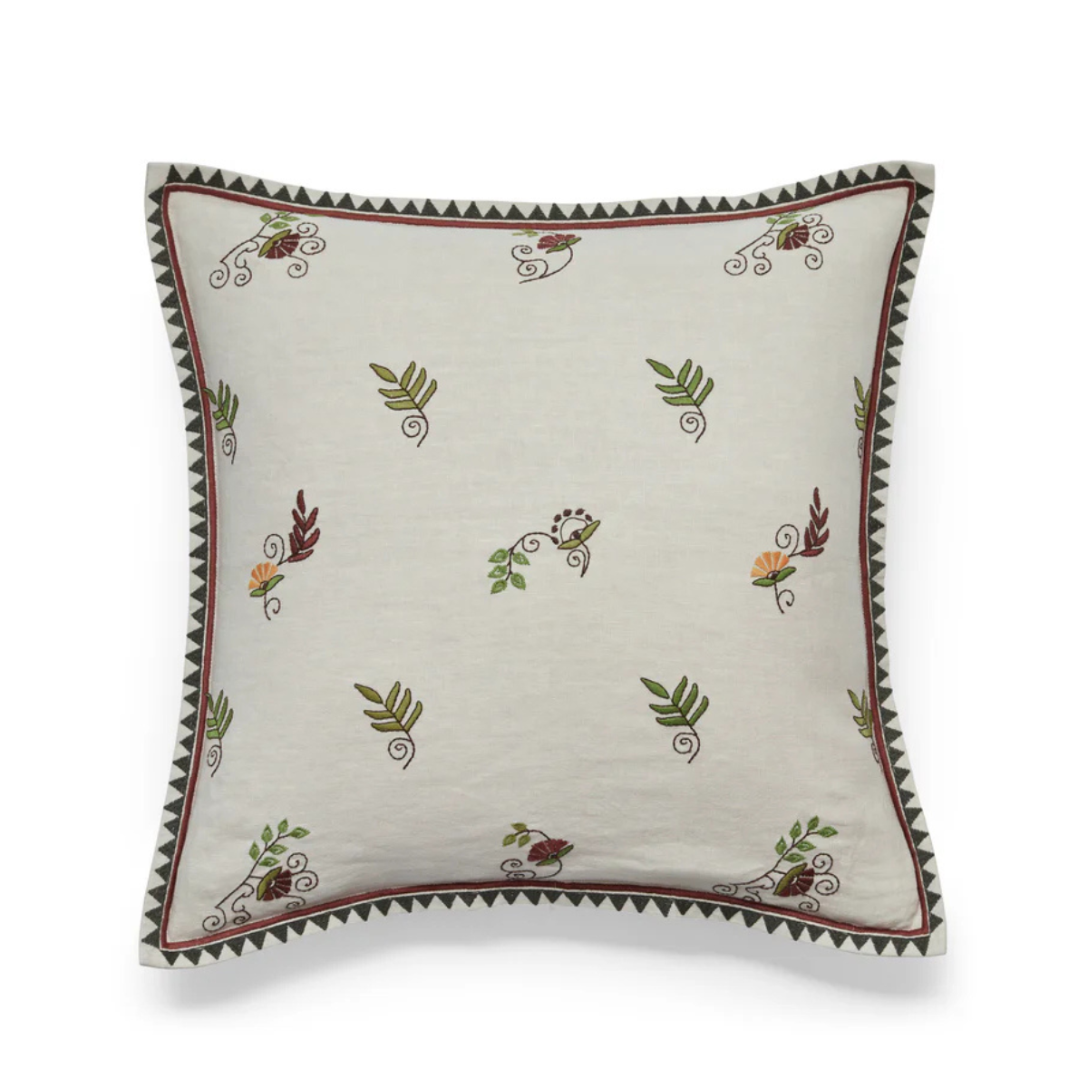 a cream cushion with floral embroidery and a zig zag trim