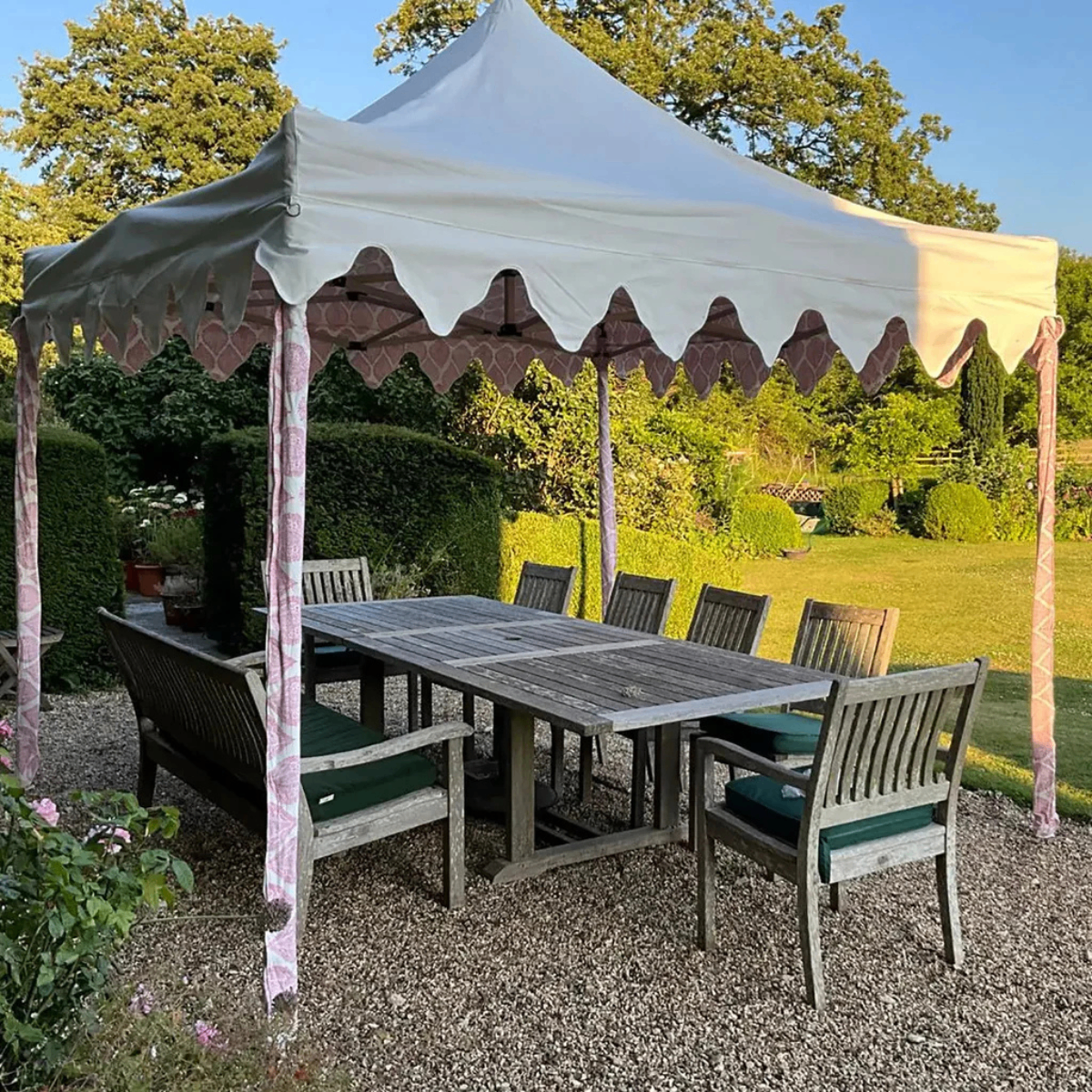 a large luxury gazebo with a scalloped edge and pink patterned canopy