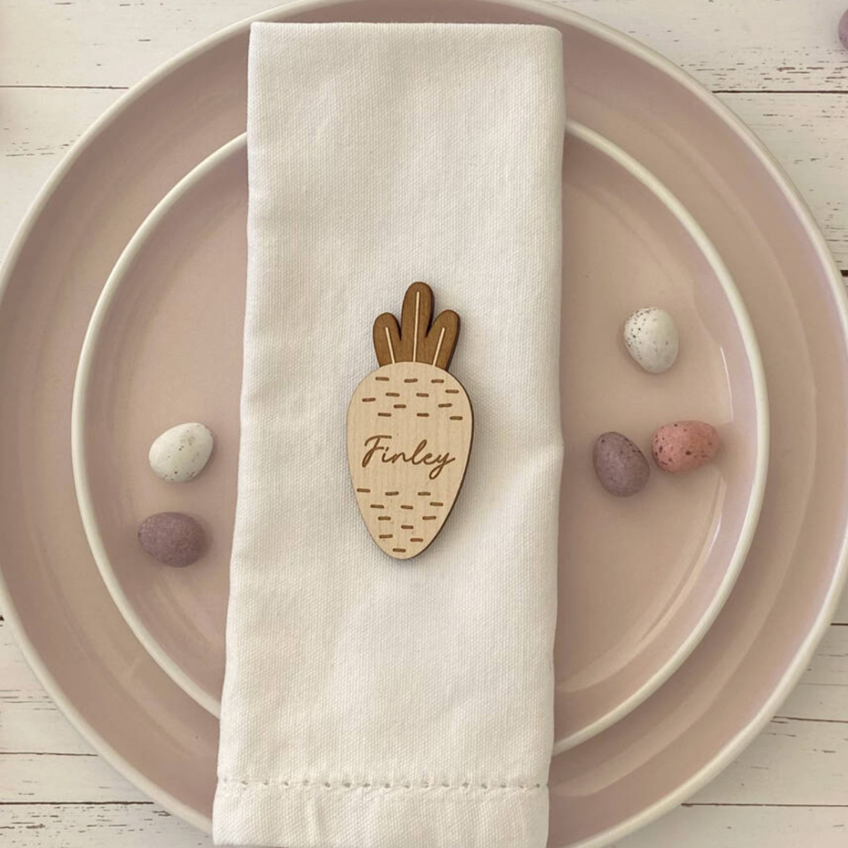 a wooden place setting in the shape of a carrot